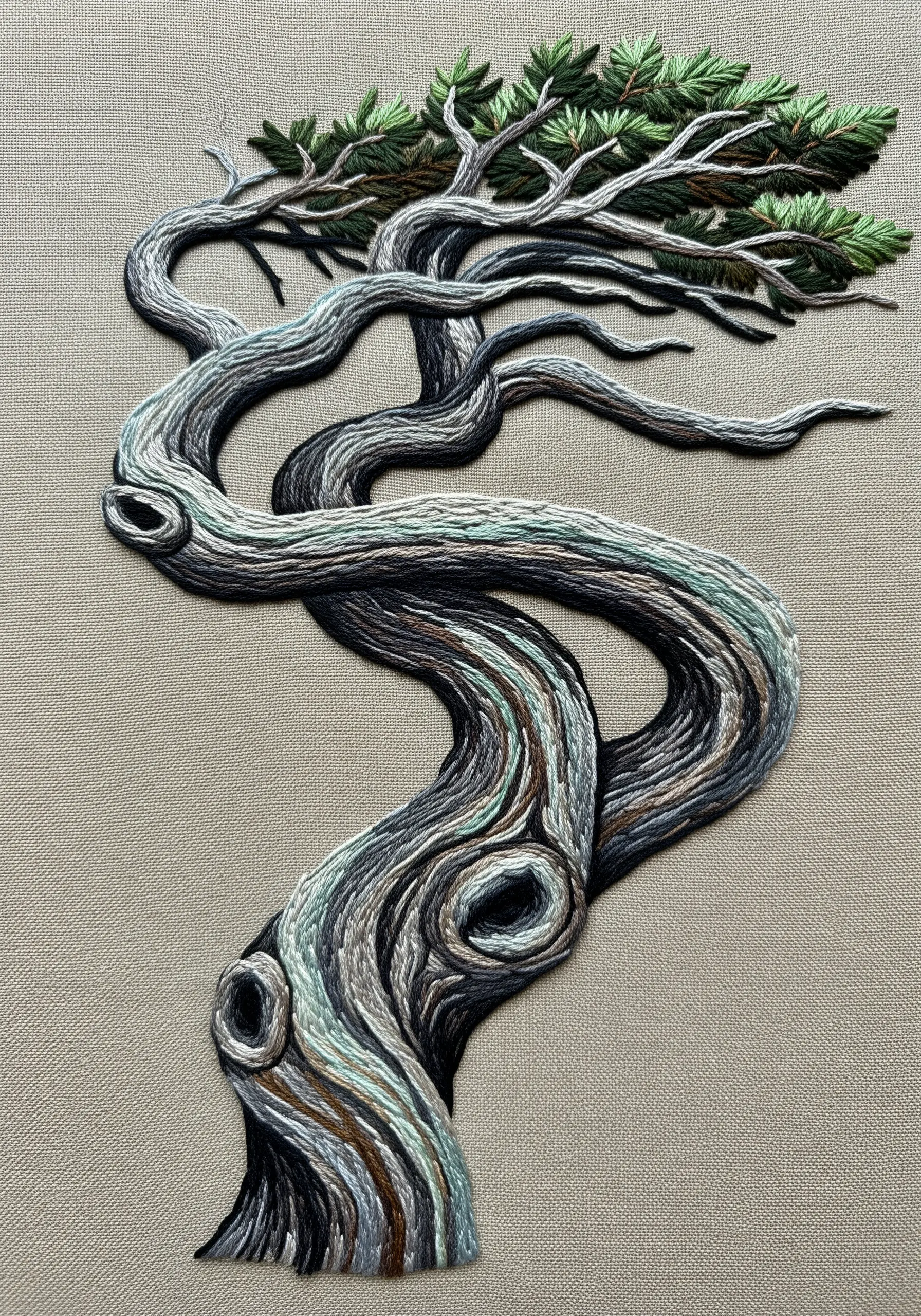 Detailed thread painting of a twisted, ancient tree trunk with stitches following its contours.
