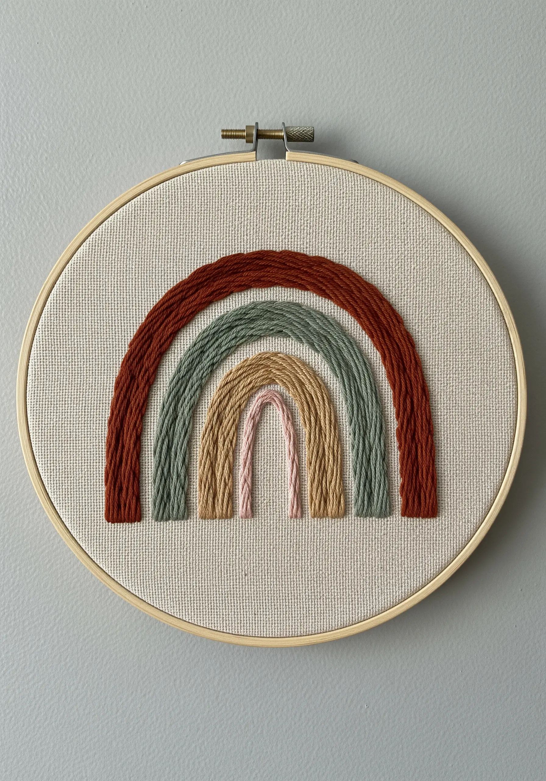 Boho style rainbow embroidery in rust green and beige tones