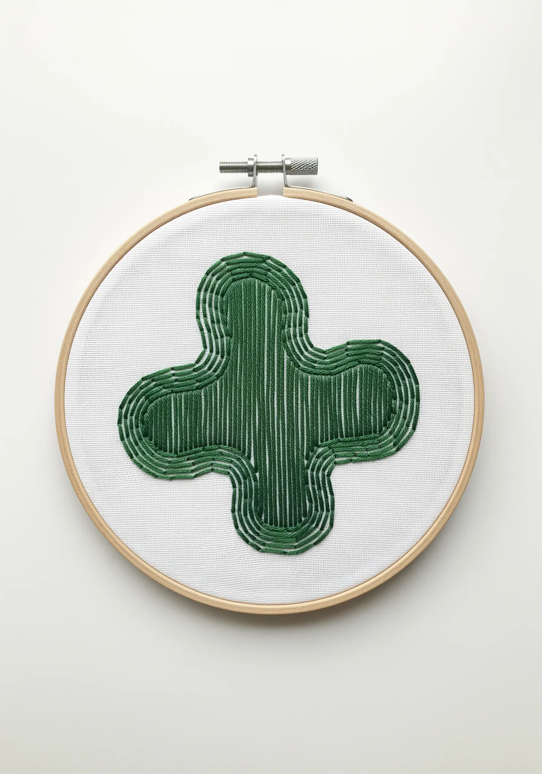 A green organic shape filled with vertical stitches and defined by multiple outlines.