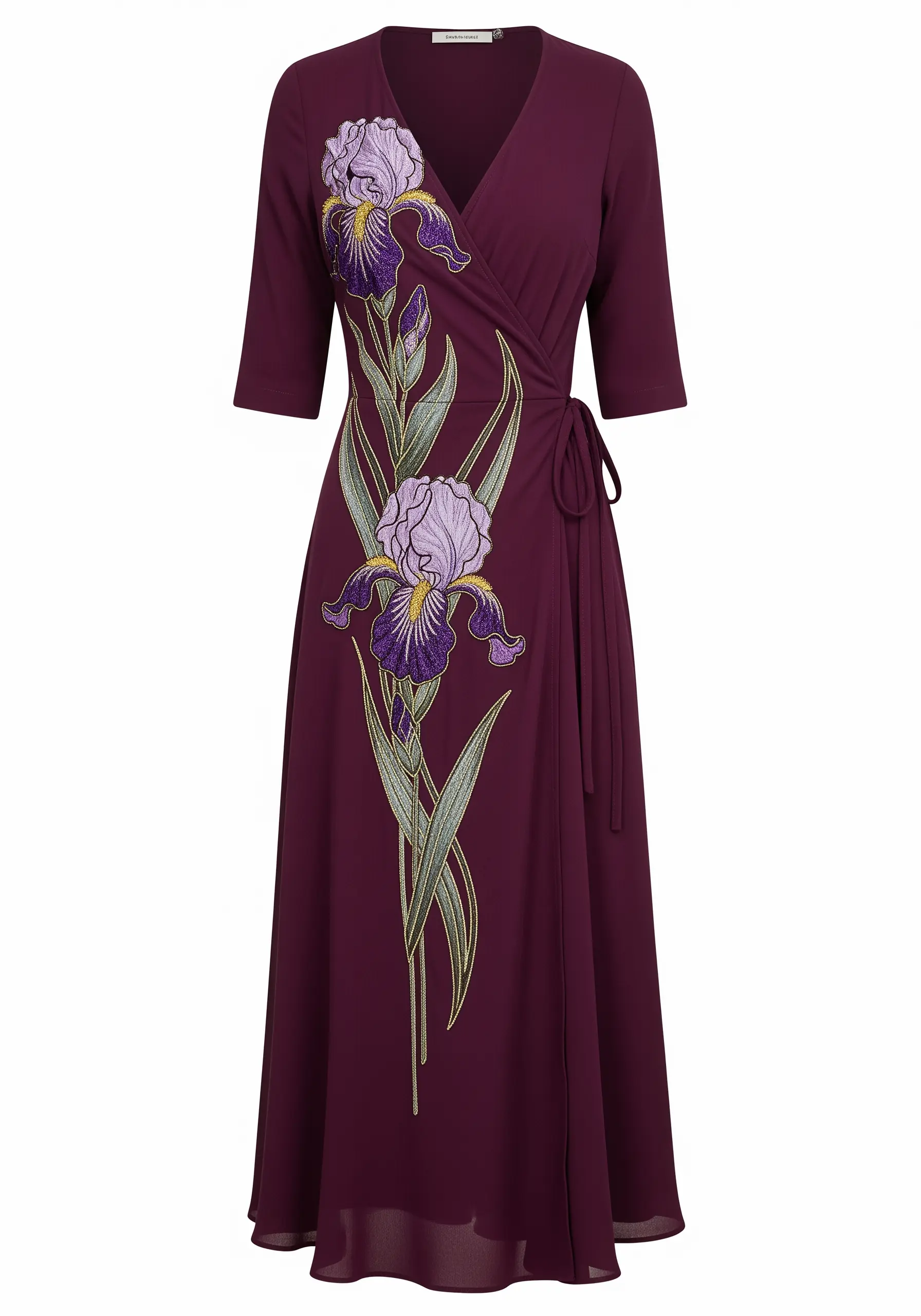 A large purple iris with glitter thread details embroidered on a deep magenta wrap dress.