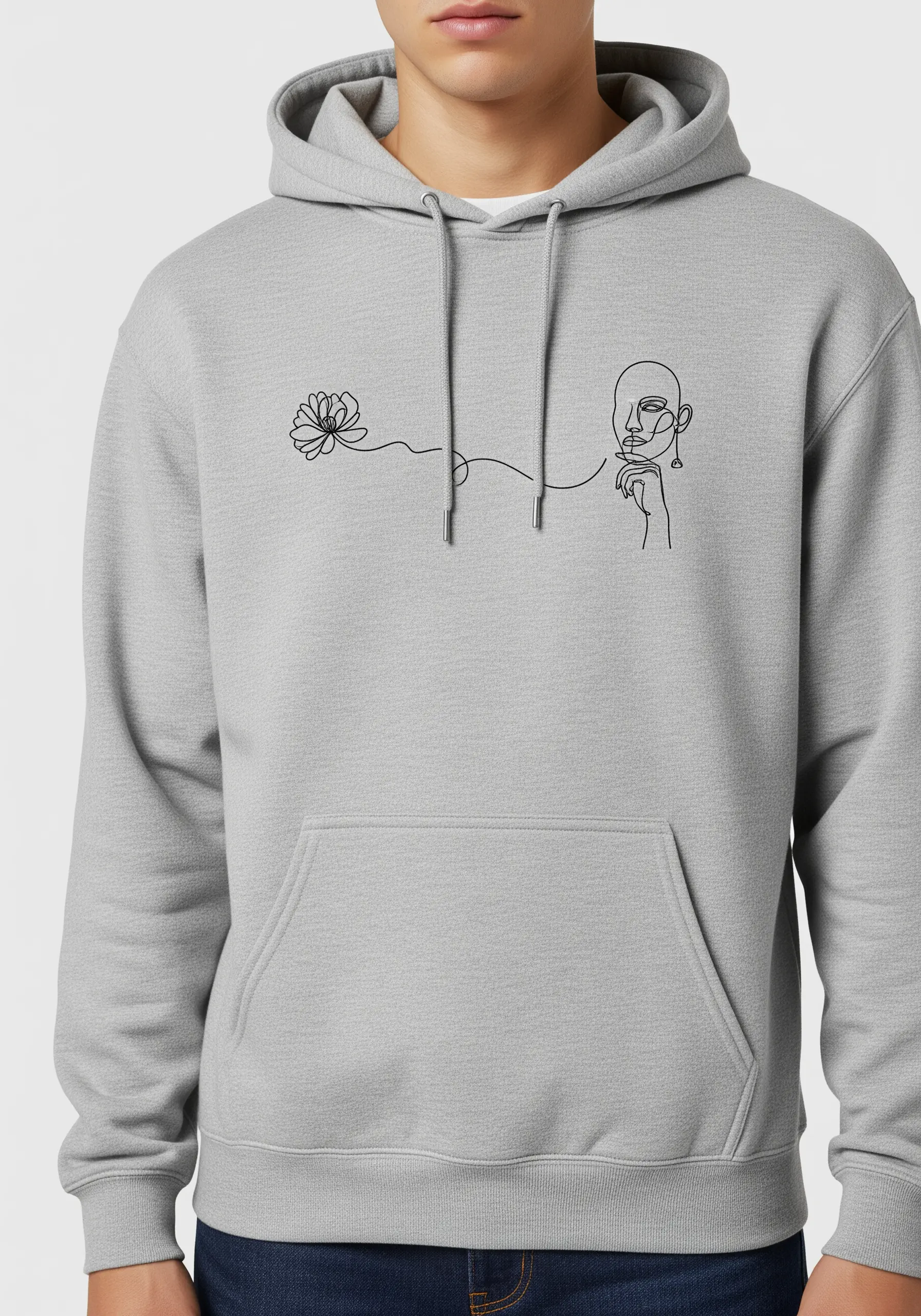Minimalist single-line art of a face and flower embroidered in black on a grey hoodie.