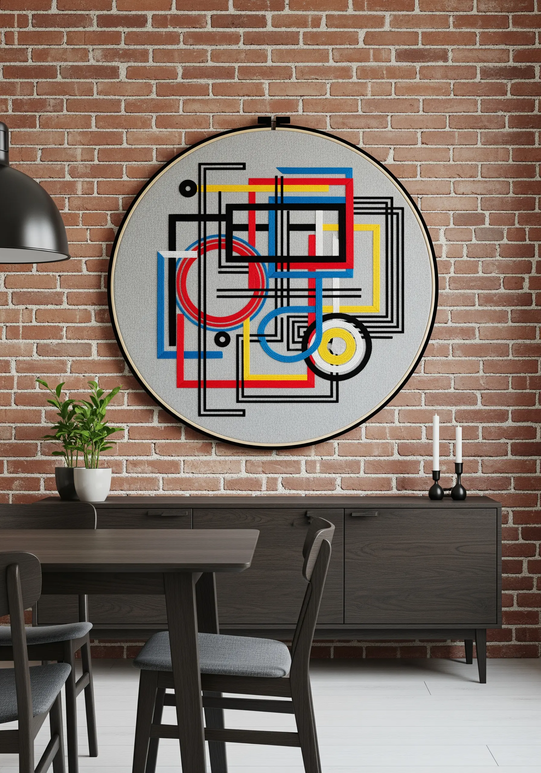 Large embroidery hoop with an abstract geometric design in primary colors and black.