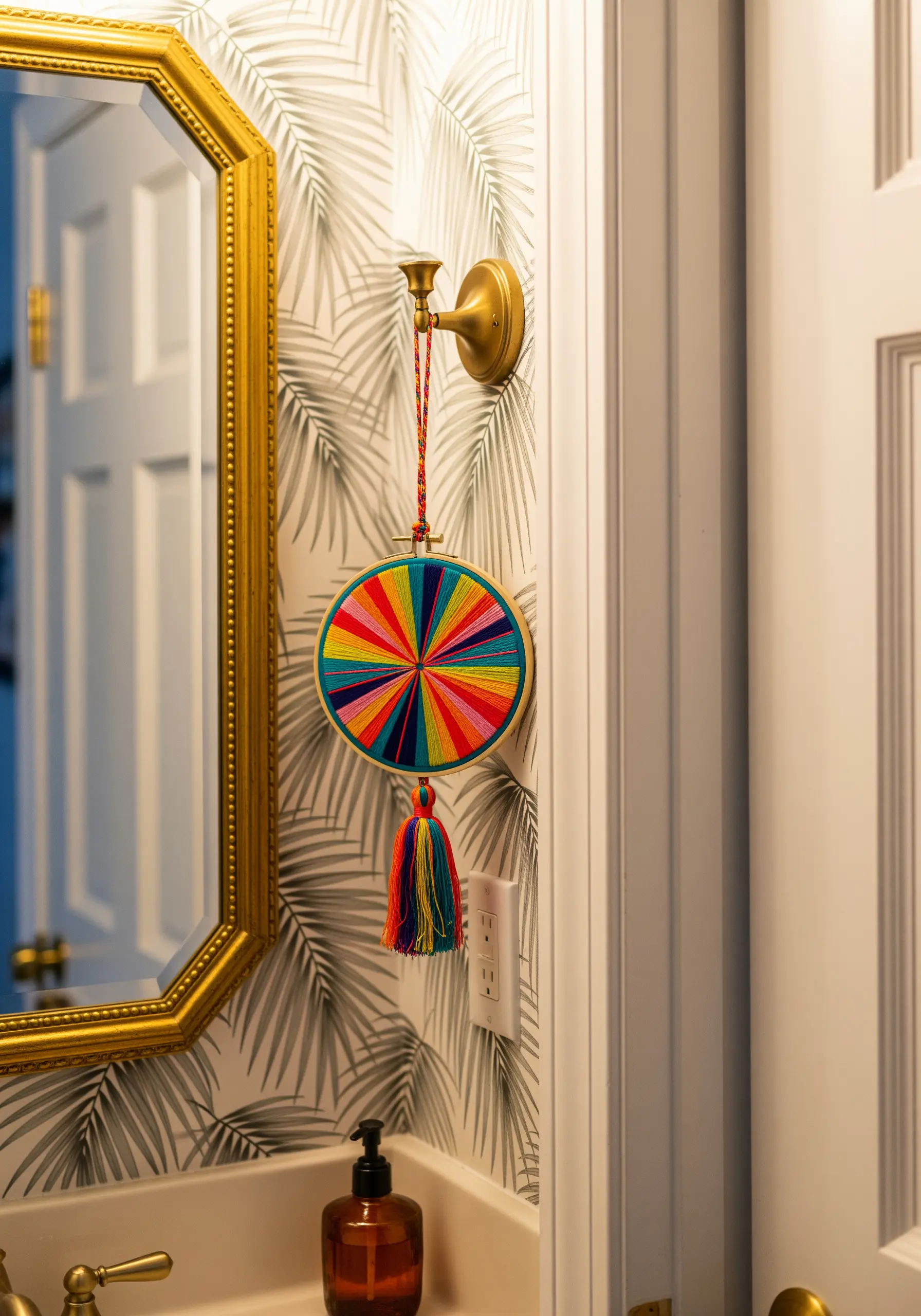 A round embroidery hoop with vibrant rainbow-colored geometric sections.