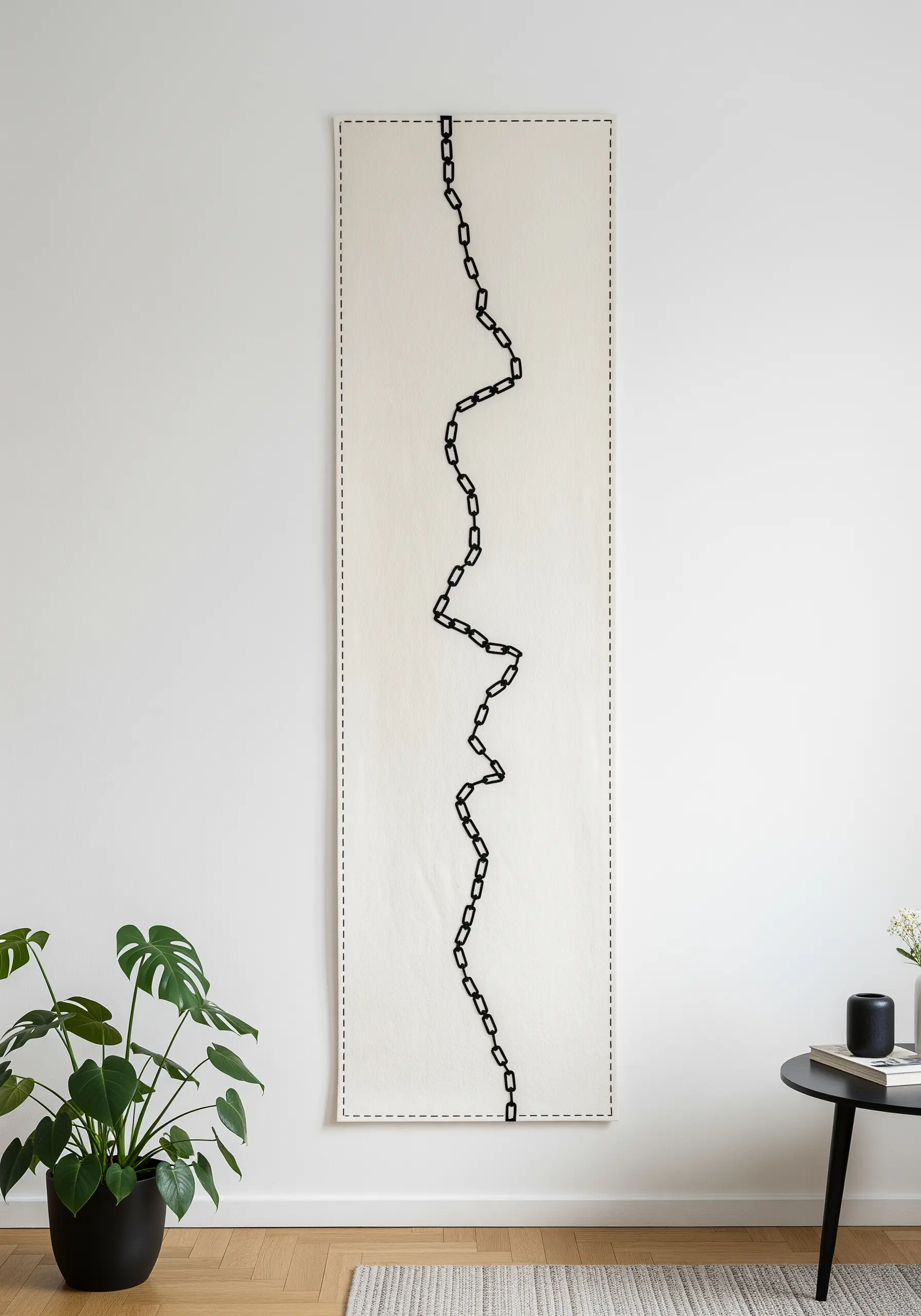A single, meandering line of black chain stitch running down a long, vertical canvas.