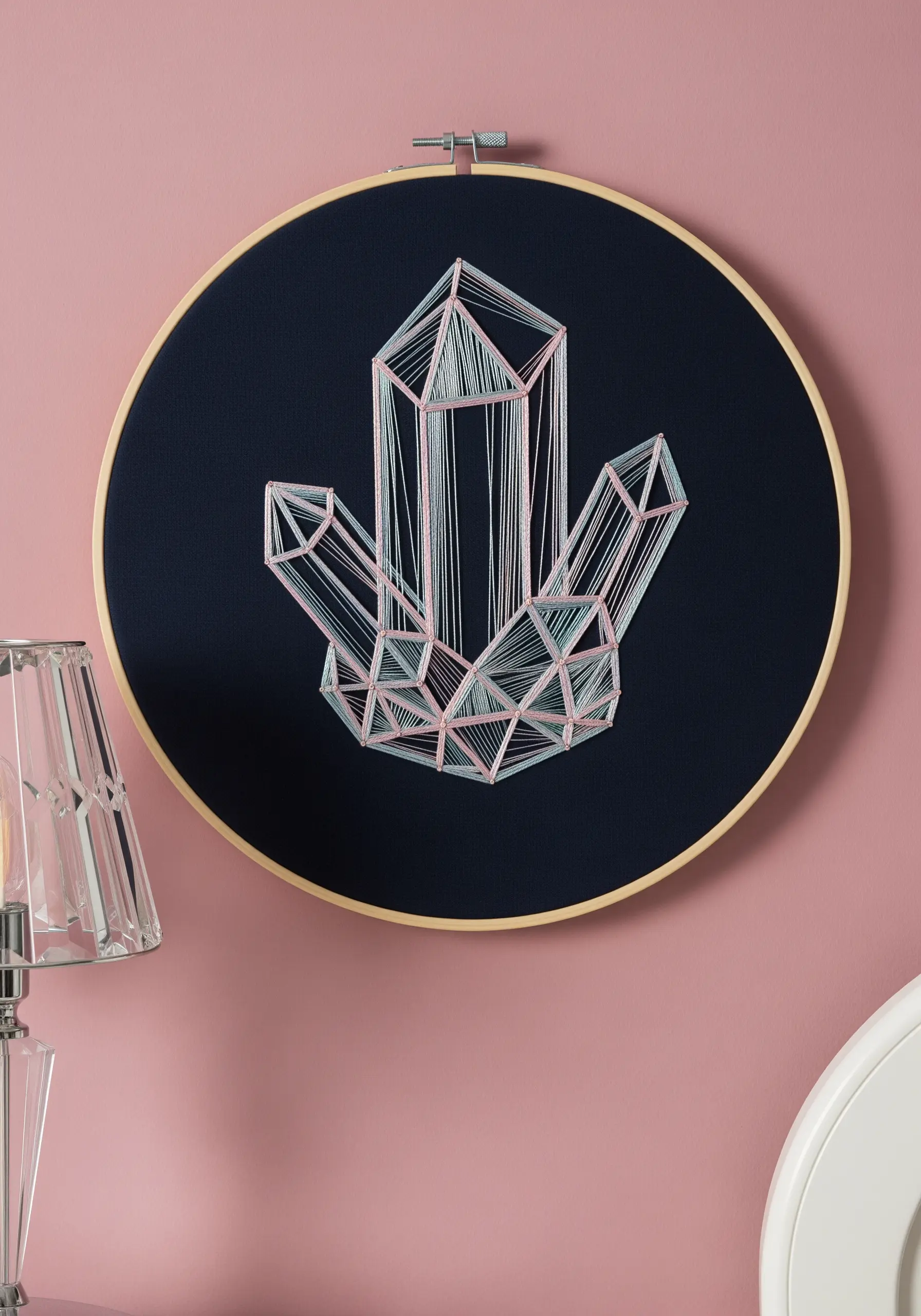 A large hoop with a geometric crystal cluster created with string art techniques.