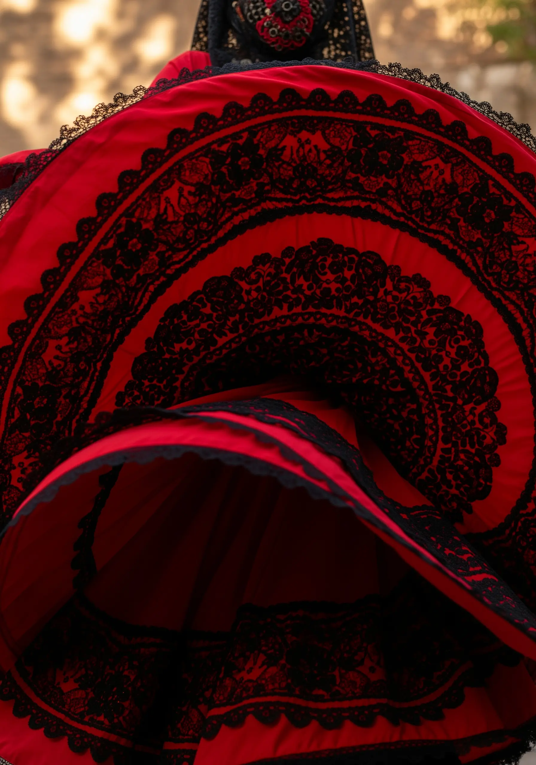 Red dress with heavy black embroidery mimicking lace layers