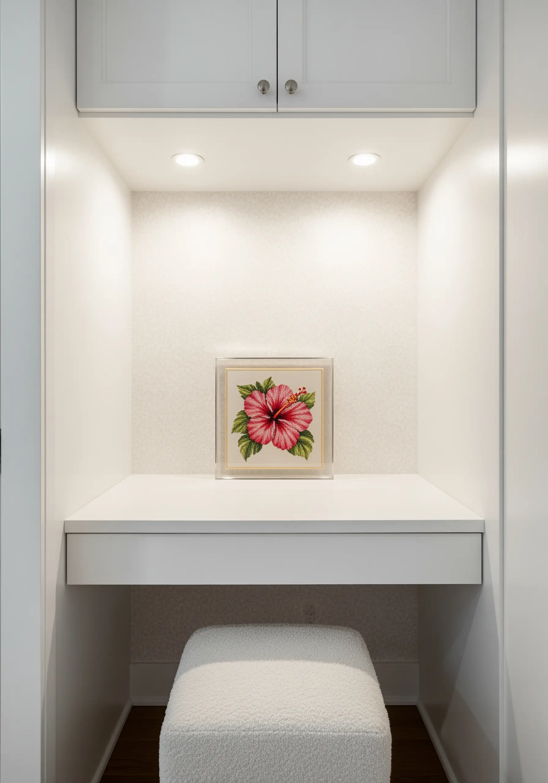 A single pink hibiscus embroidery displayed in a clear acrylic box frame.