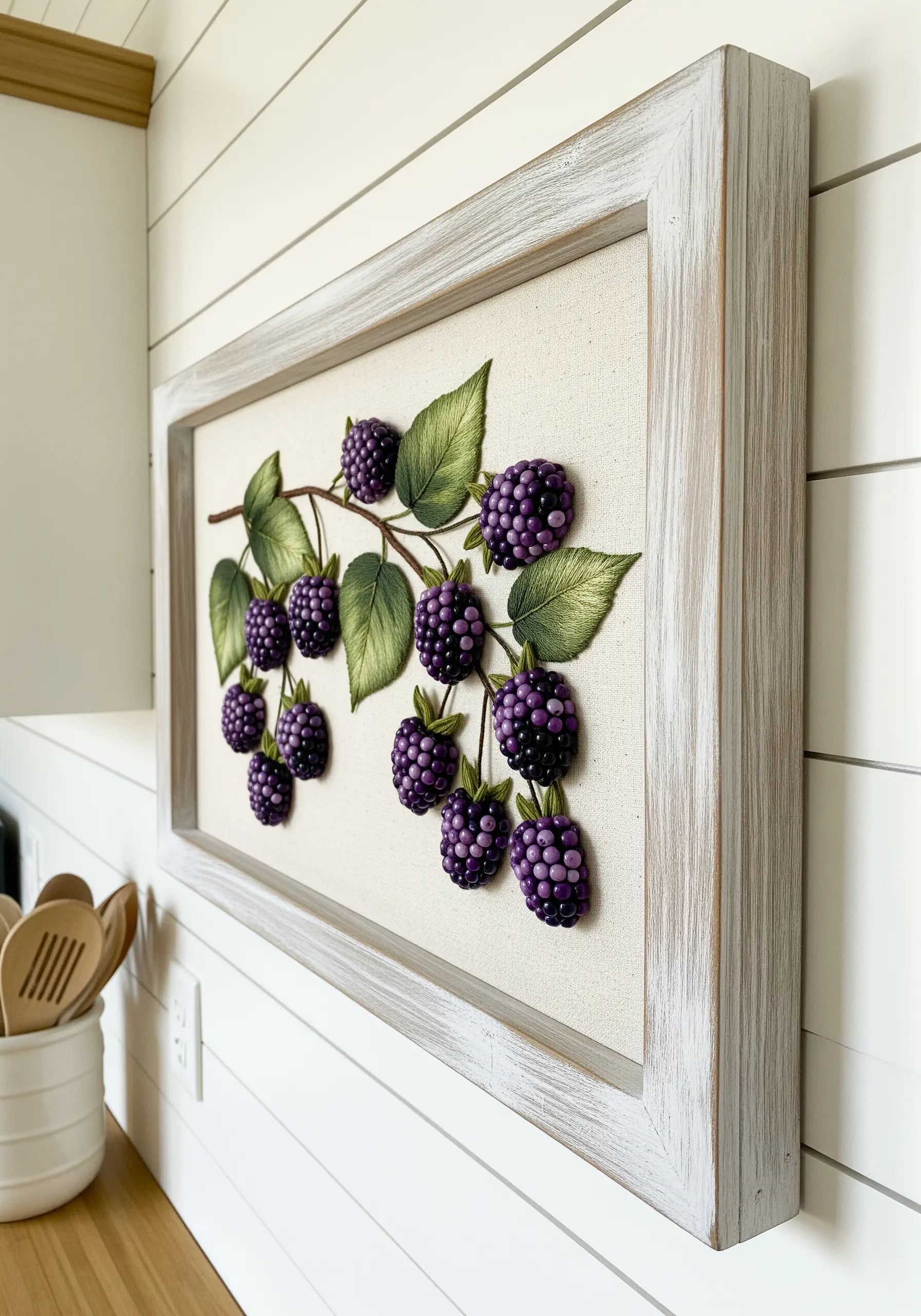 Framed 3D embroidery of a blackberry branch with plump, textured purple berries