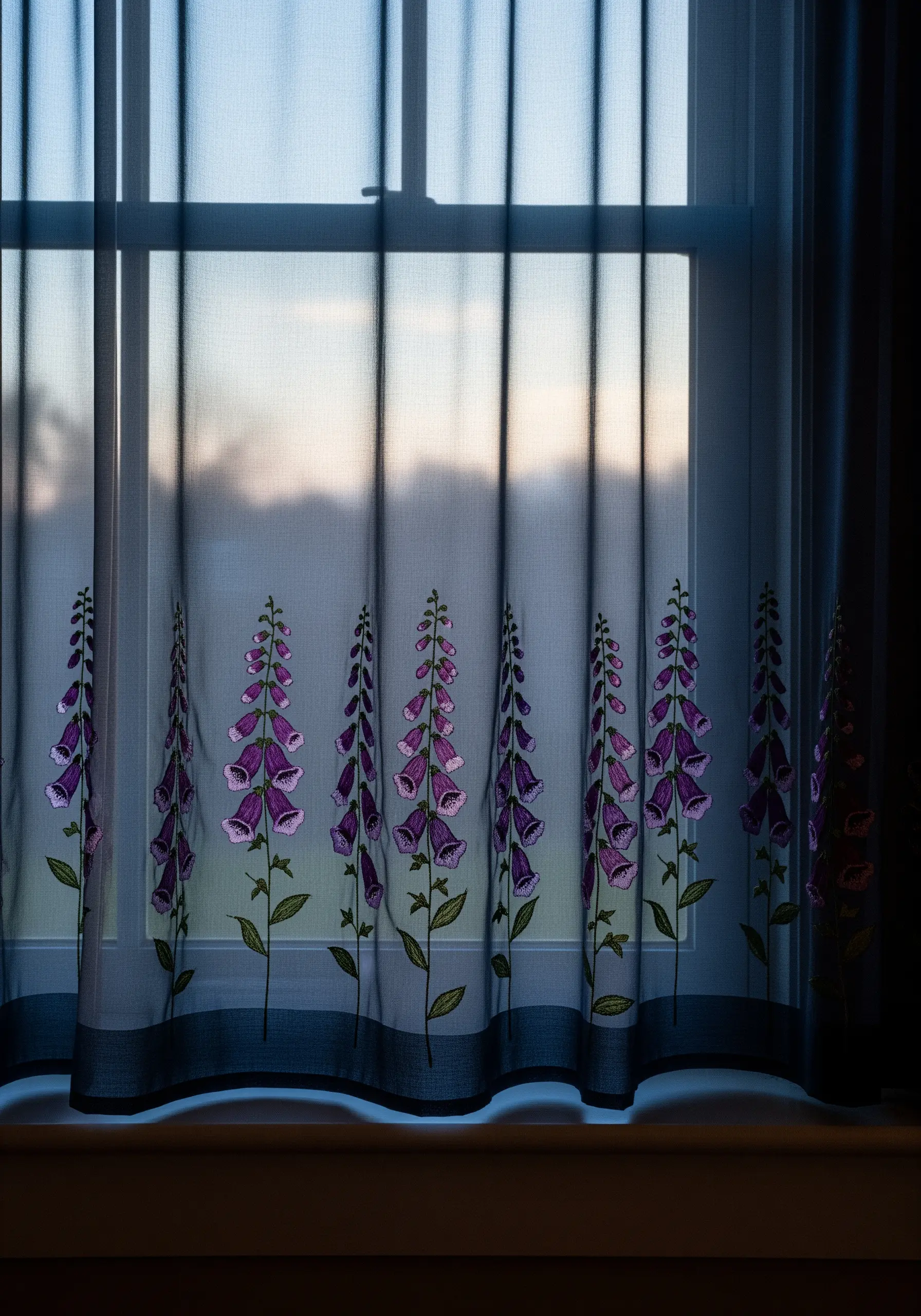 Embroidered purple foxglove flowers on a sheer window curtain.