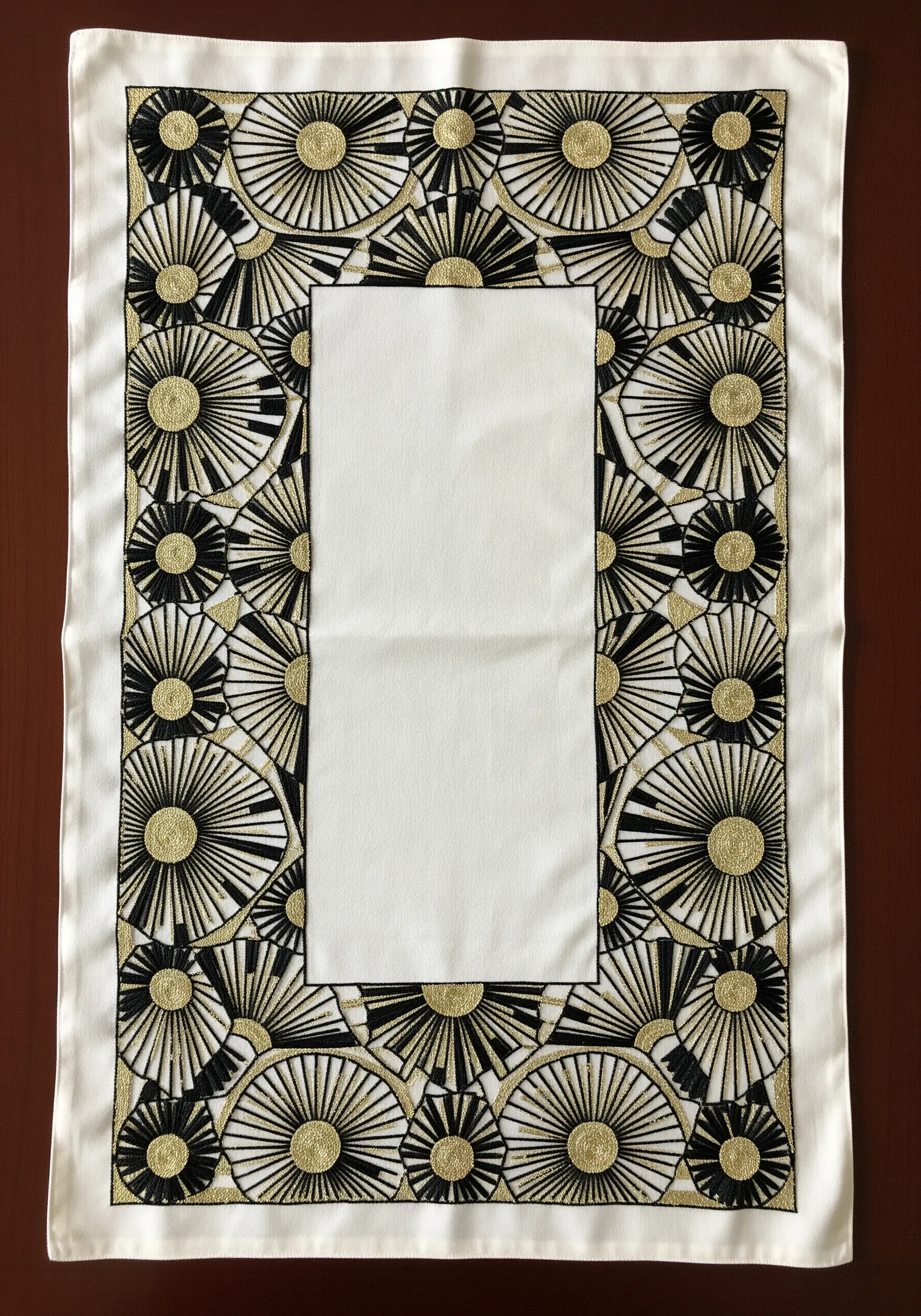 An Art Deco placemat with gold and black embroidered sunburst patterns forming a border.