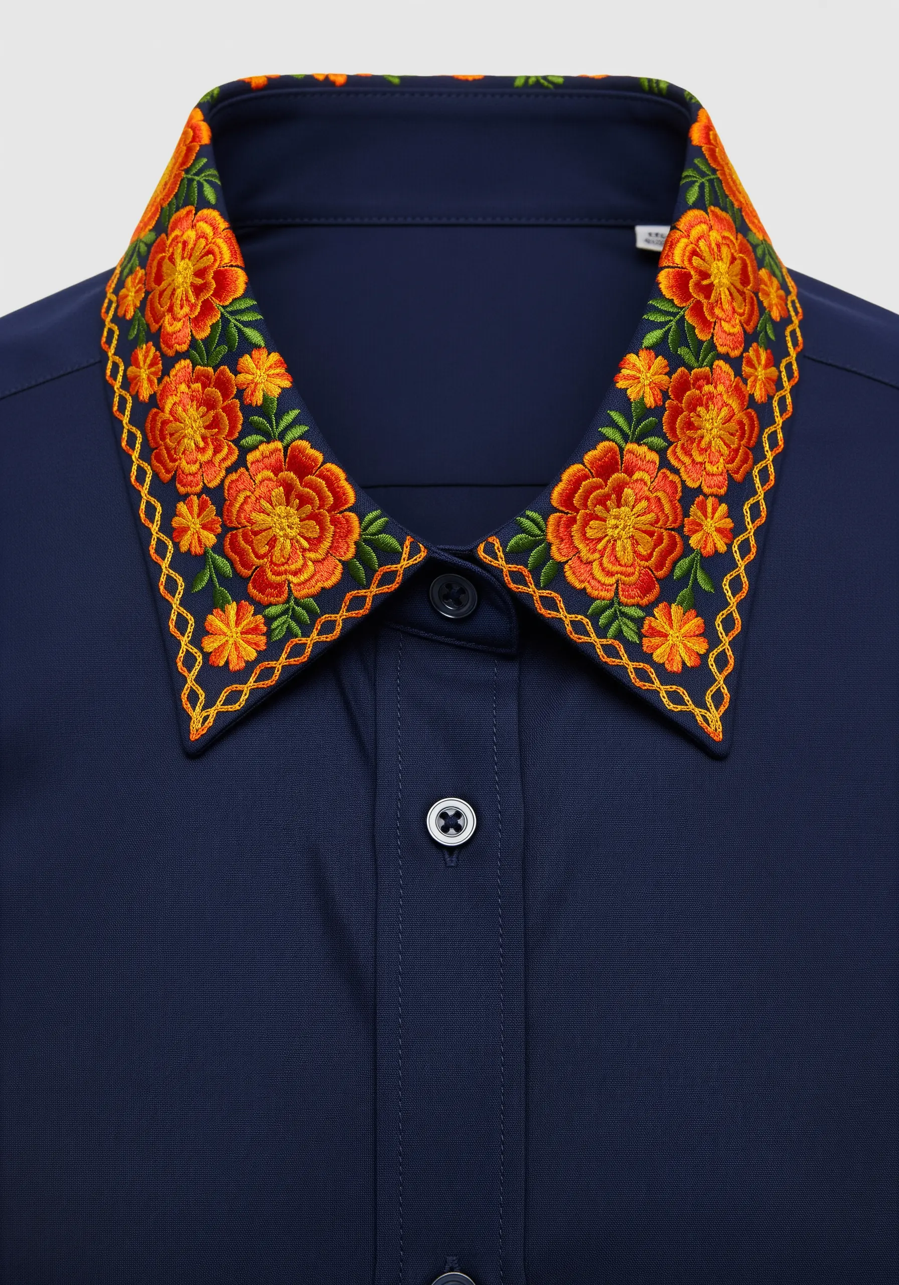 Vibrant orange and yellow marigolds framed with a decorative border on a navy shirt collar.