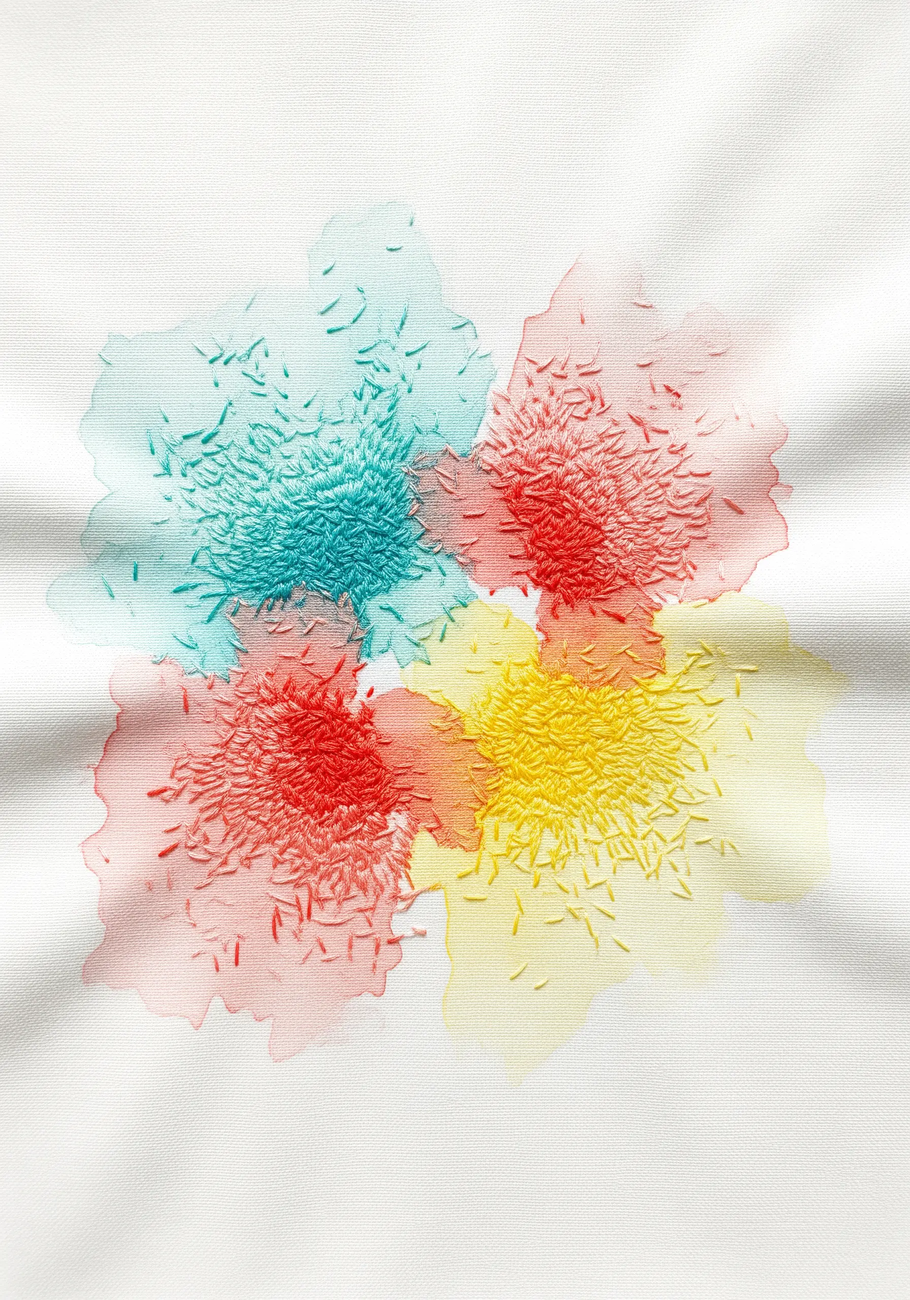 Seed stitches embroidered over soft watercolor patches in red, yellow, and teal.