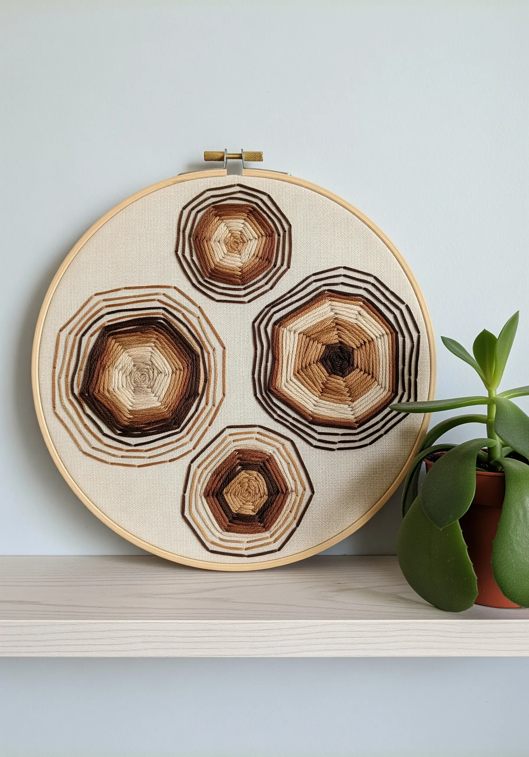 Four geometric wood slice patterns embroidered in brown tones