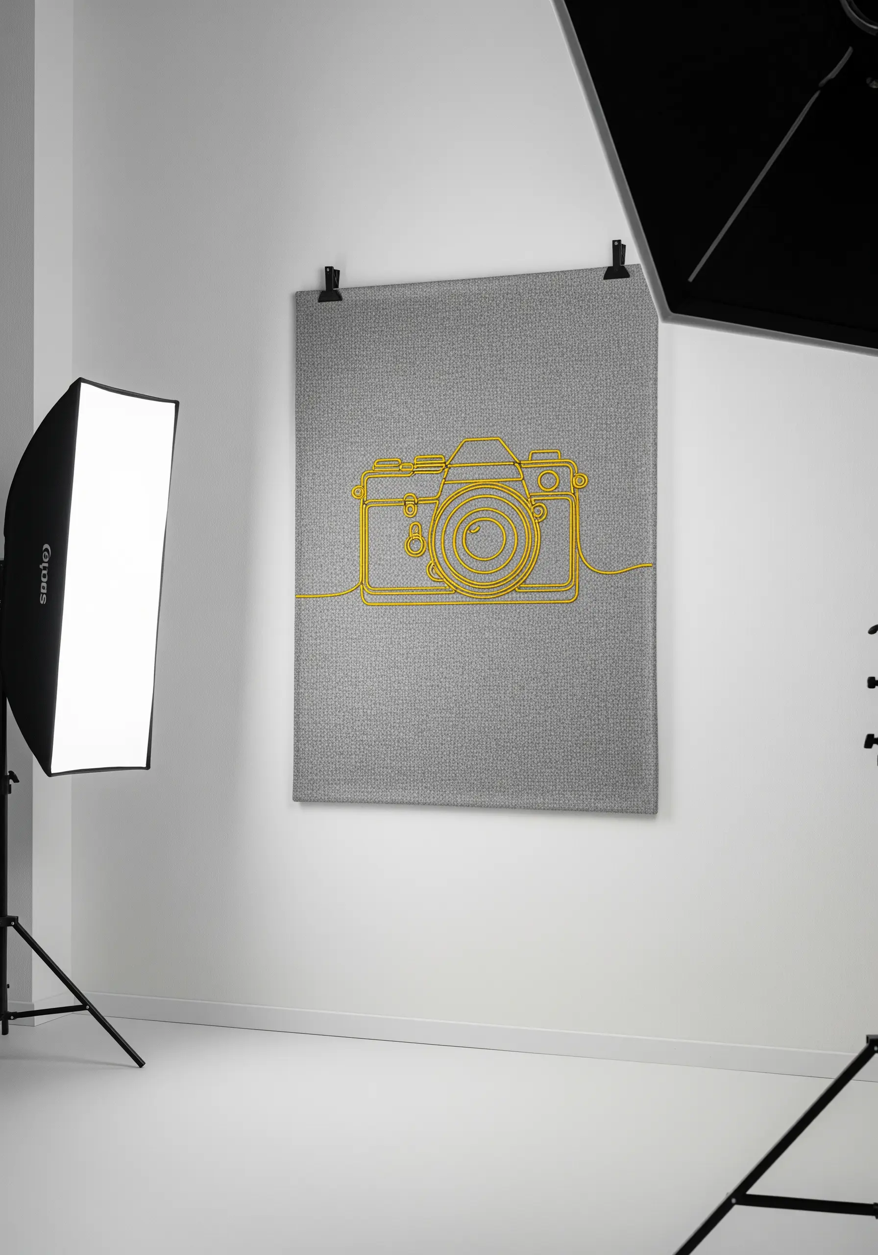 A vintage camera outlined in thick, bright yellow cord on a grey textile hanging.