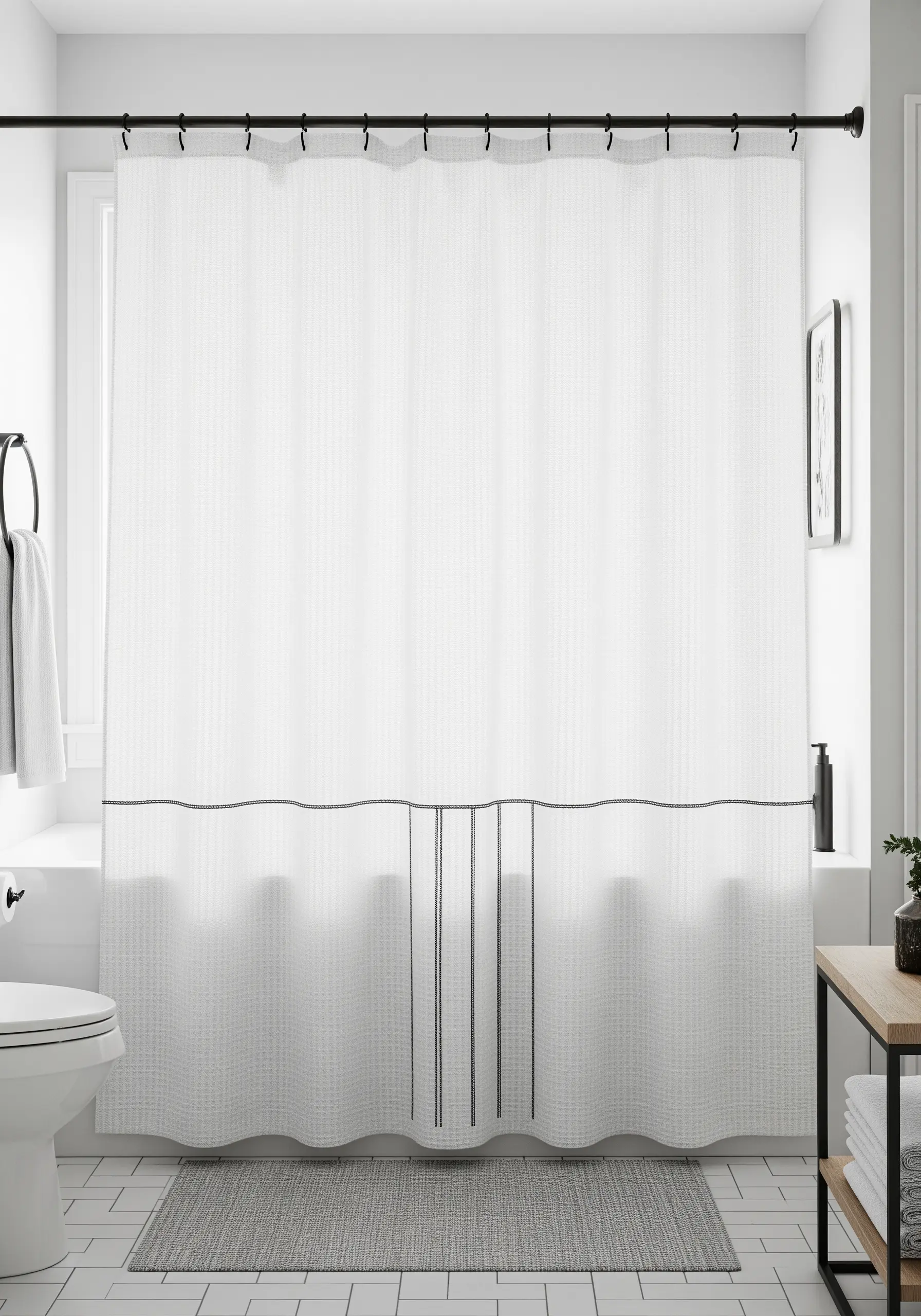 Simple black embroidered lines forming a border and vertical stripes on a white shower curtain.