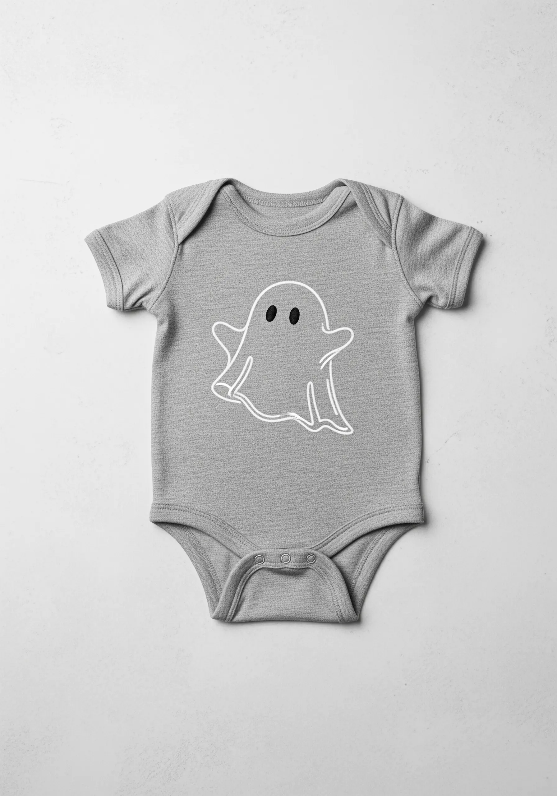 A simple white outline of a cartoon ghost on a gray baby onesie.