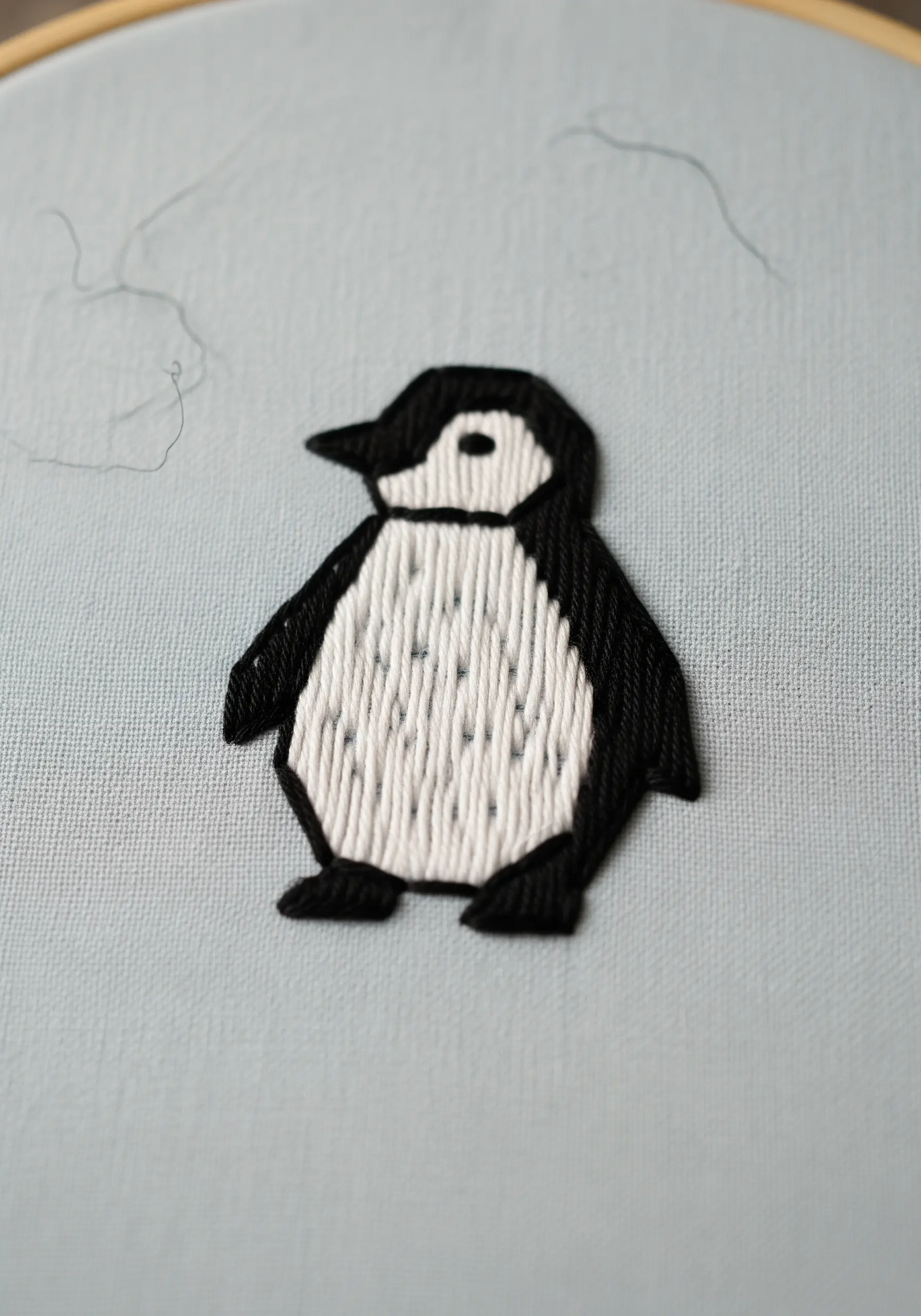 Penguin embroidery with vertical stitching for the white belly feathers