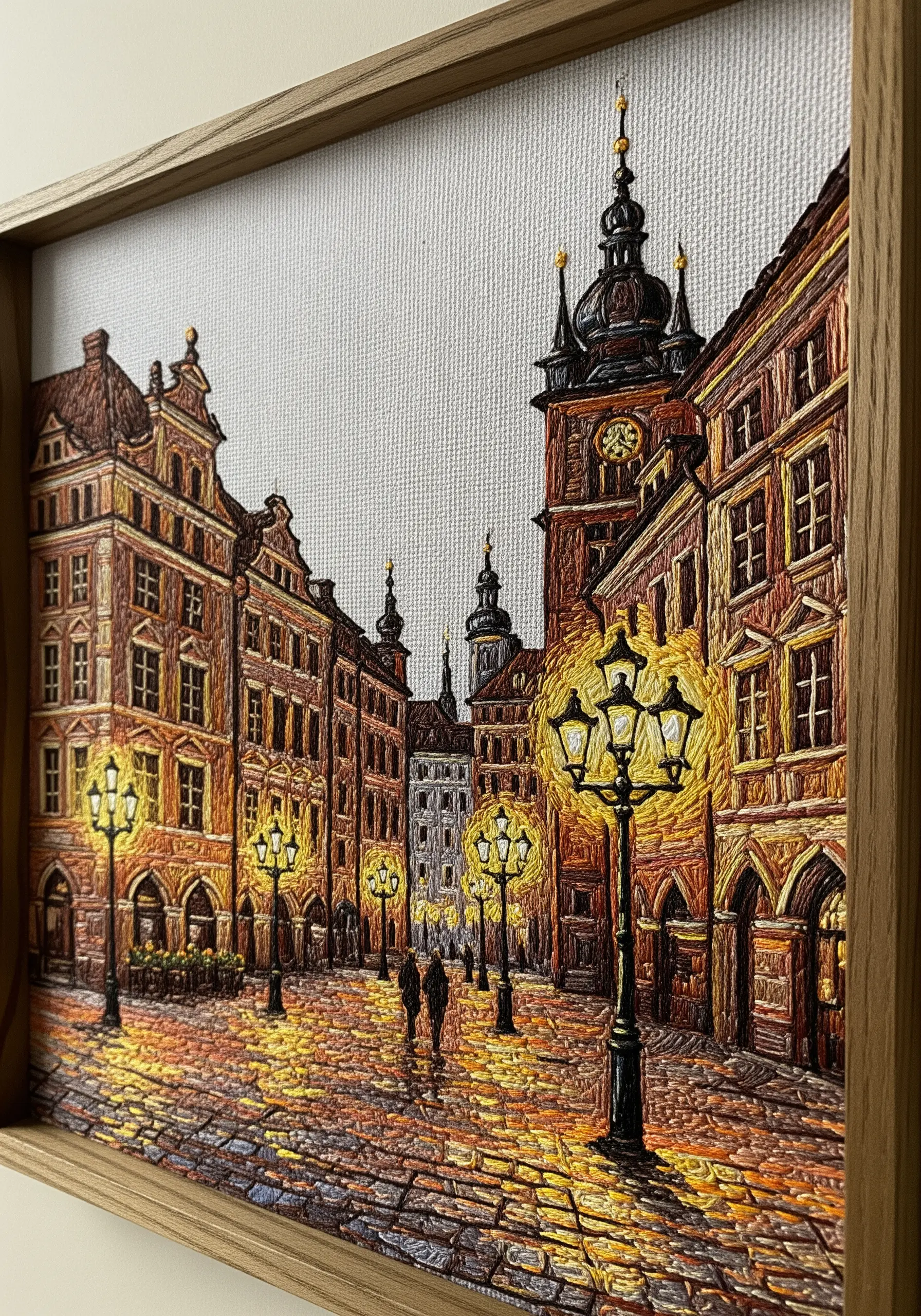 Detailed thread-painted embroidery of a historic European city street at night.