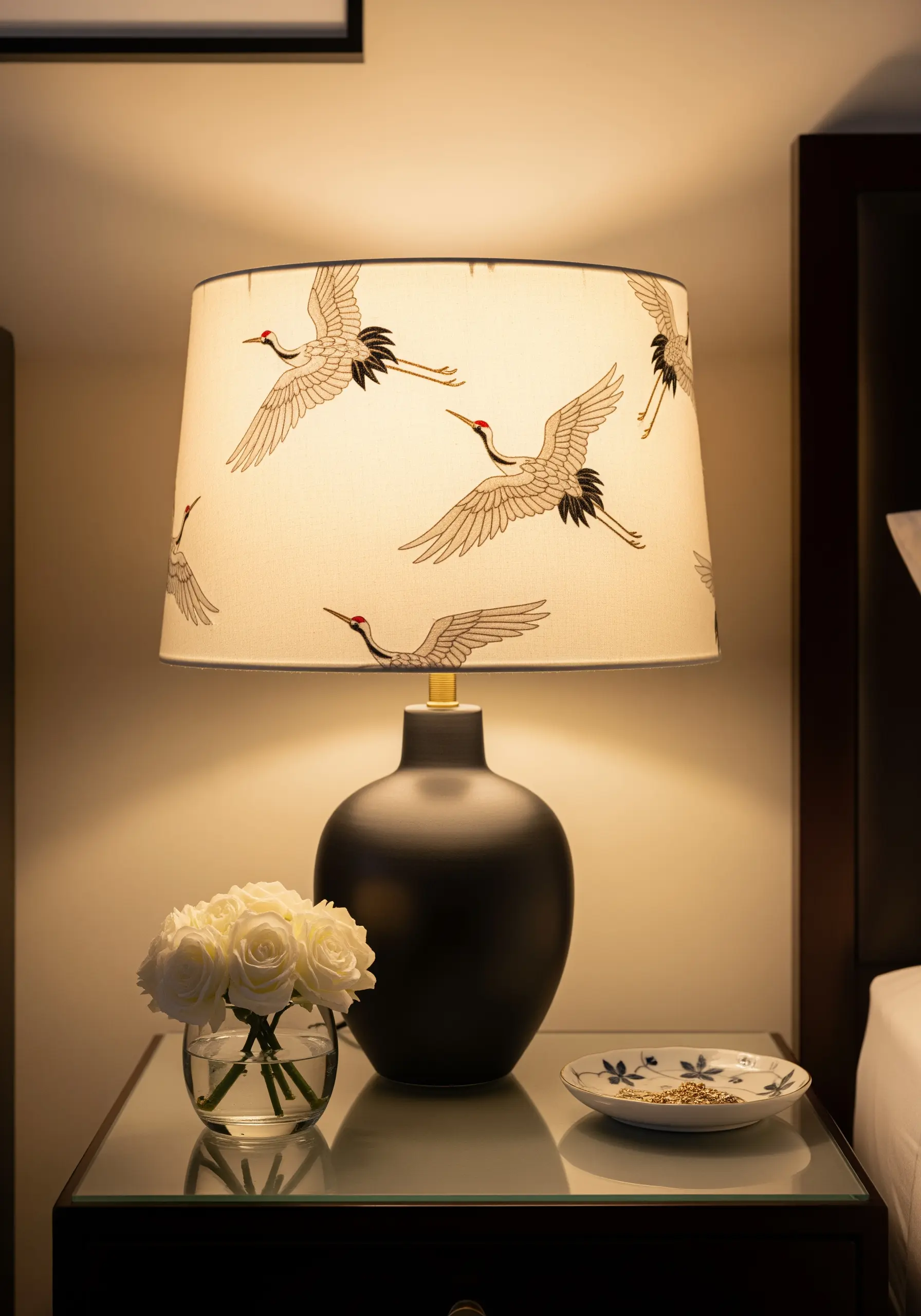 An elegant, minimalist lampshade embroidered with the outlines of flying cranes.
