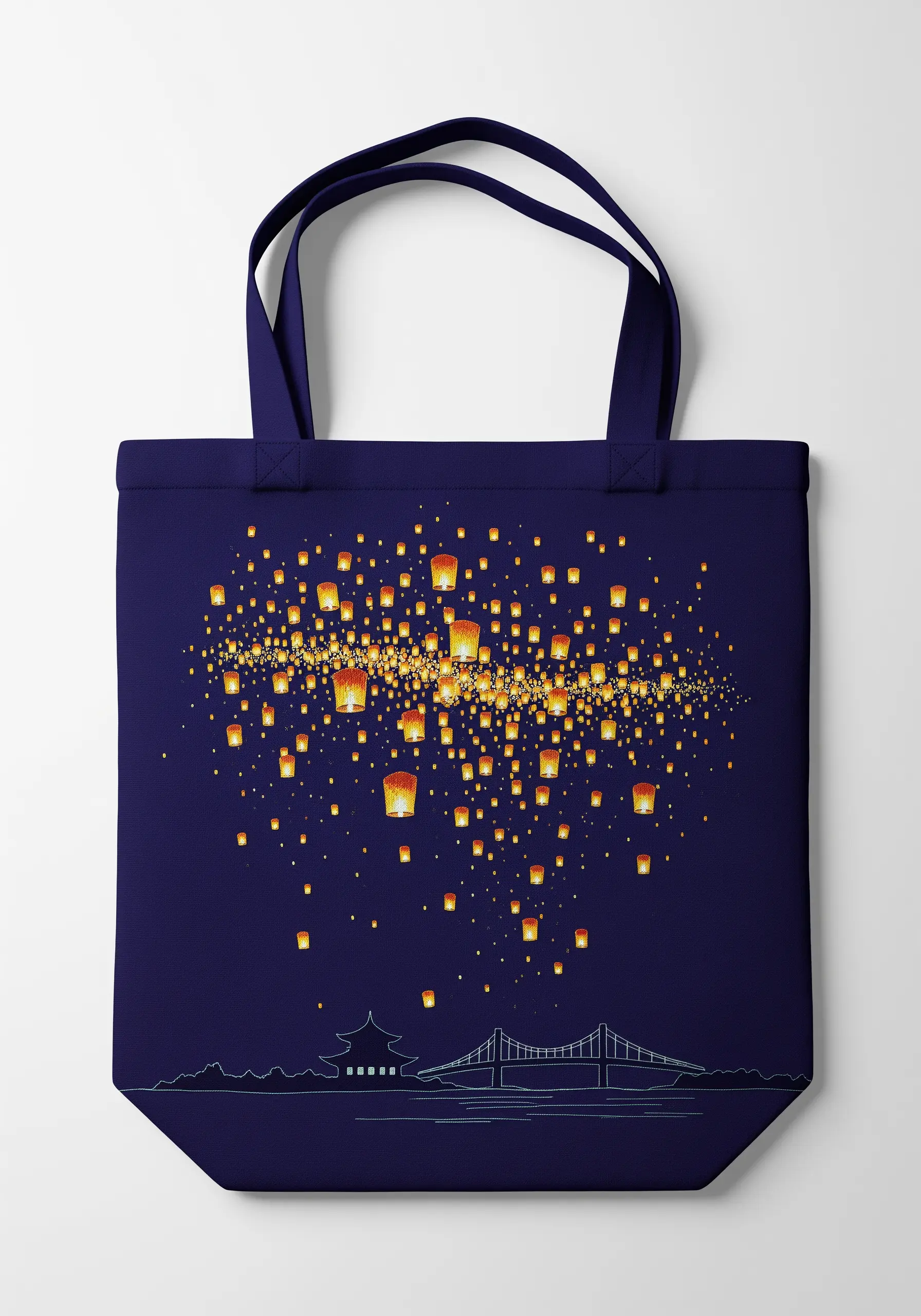 A sky full of glowing floating lanterns embroidered over a silhouette of a landscape.
