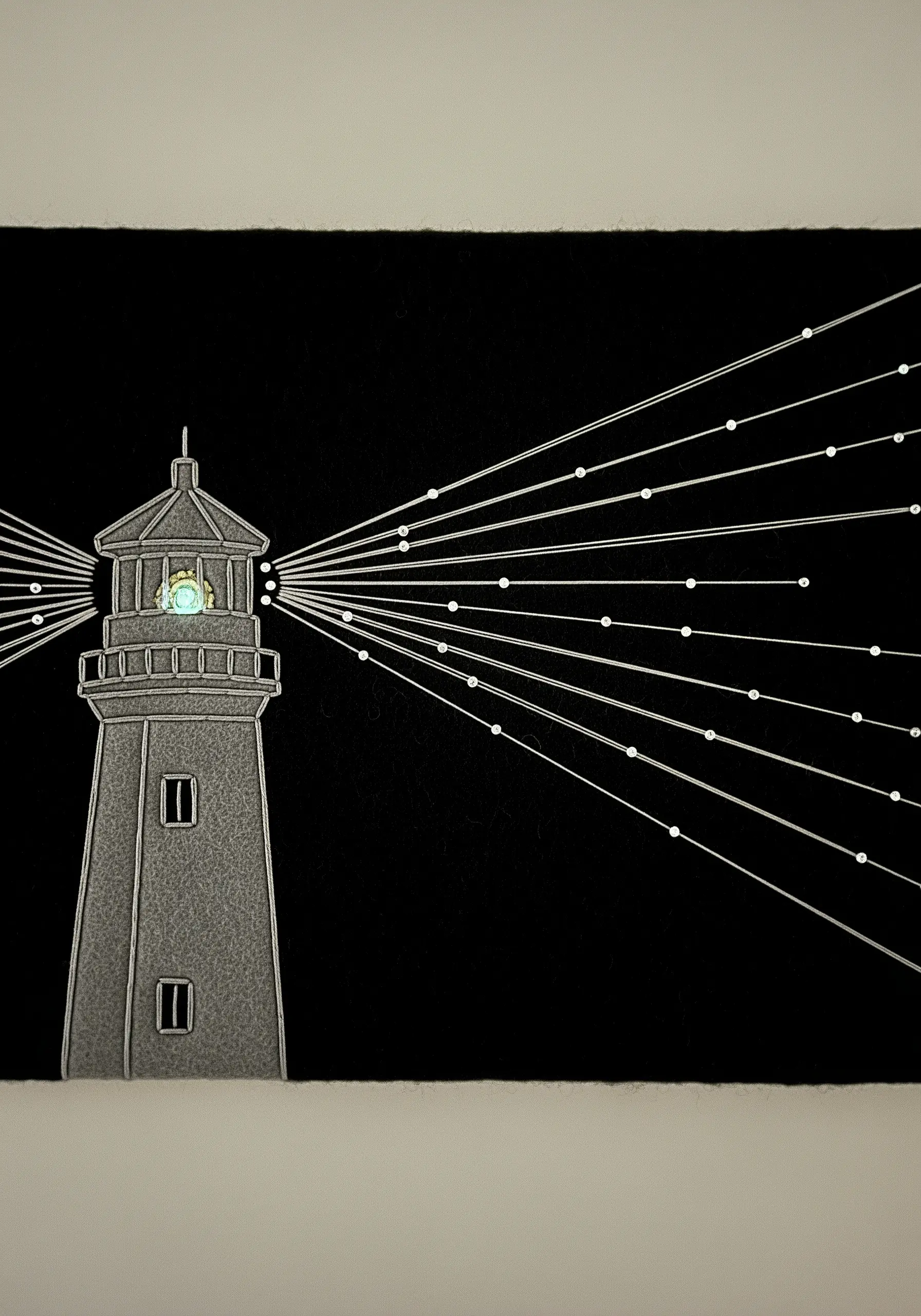 A minimalist lighthouse made from paper and thread, with straight stitches for light beams.