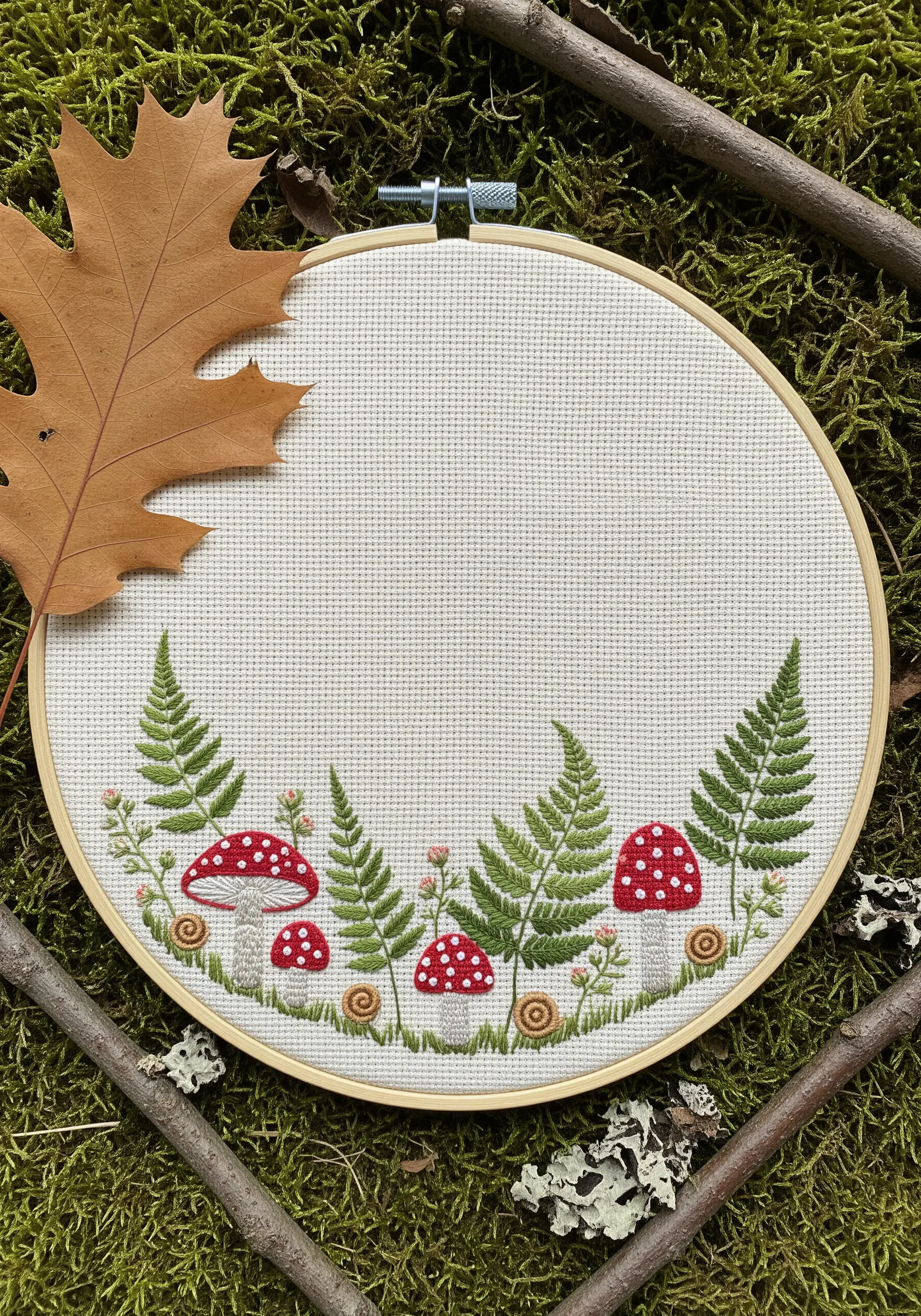 Embroidered woodland scene with red and white mushrooms, green ferns, and tiny snails.