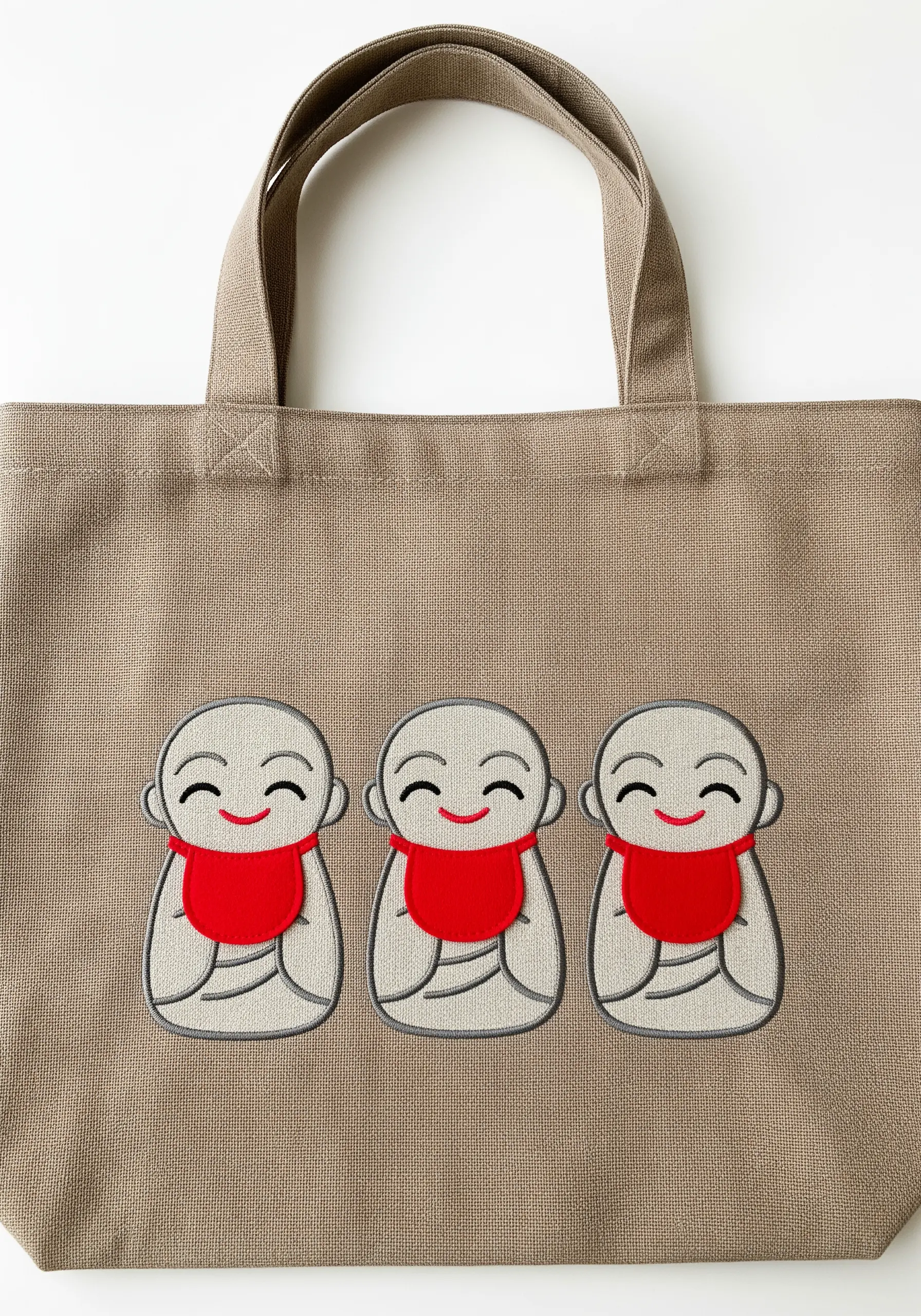 Three serene, minimalist Jizo statues embroidered with subtle grey shading.