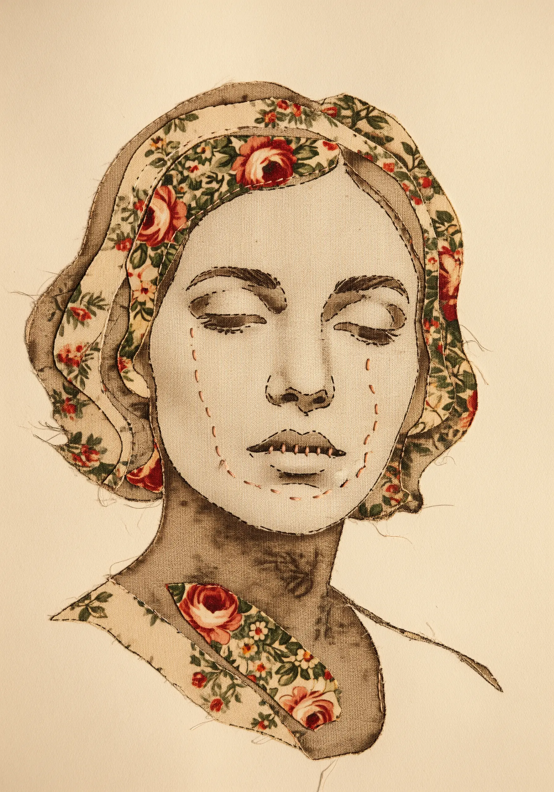 Fabric collage portrait with floral fabric used for hair and collar details.