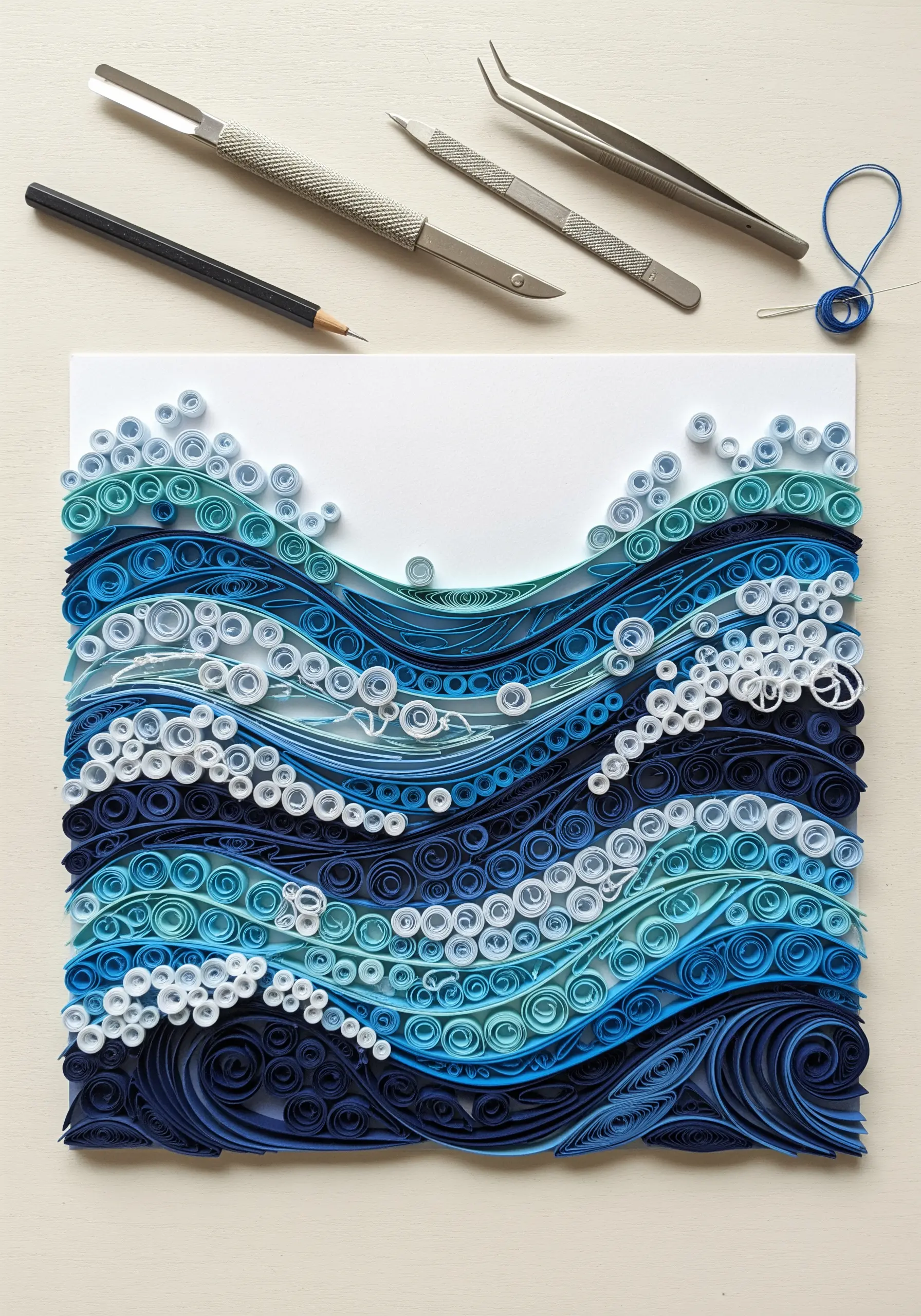 Blue quilled paper waves resembling ocean water