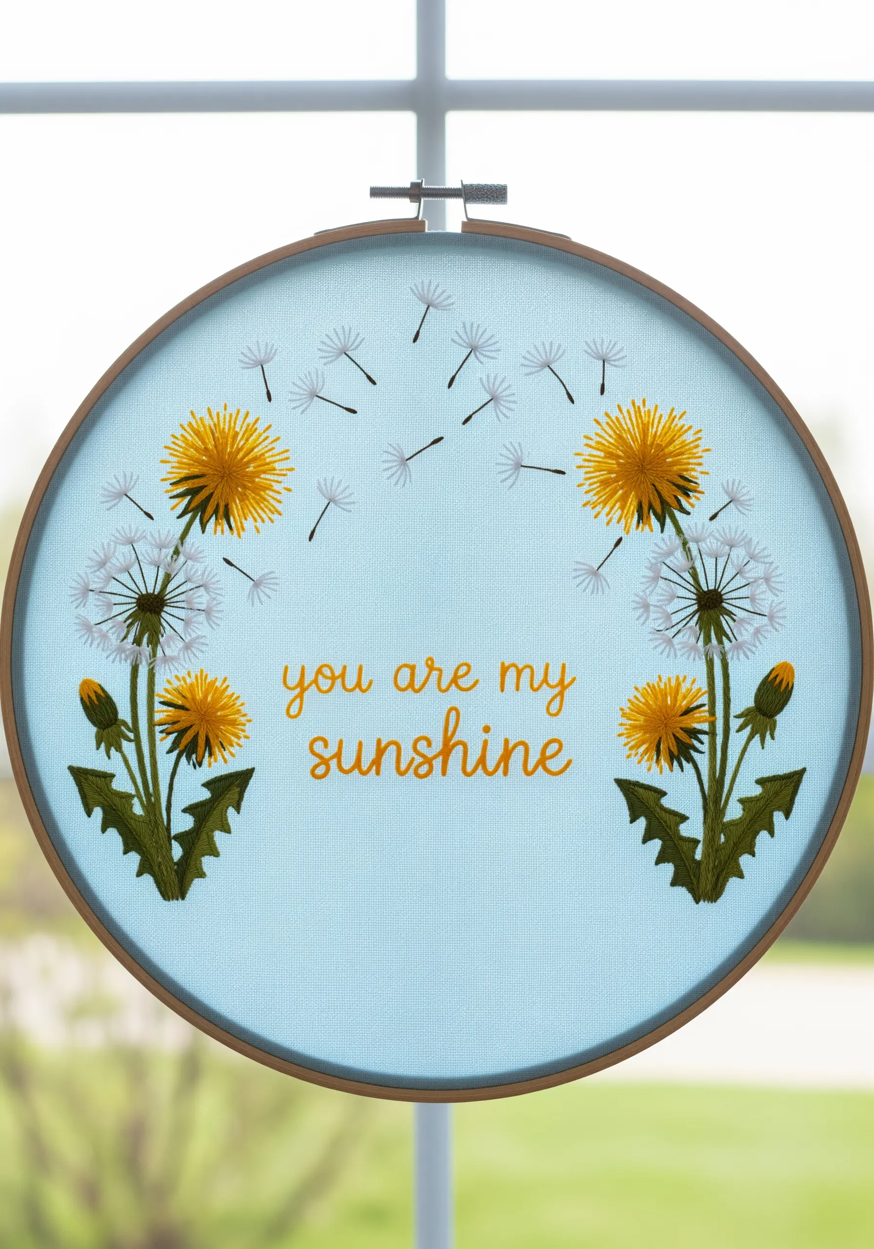 Embroidered dandelions with the quote 
