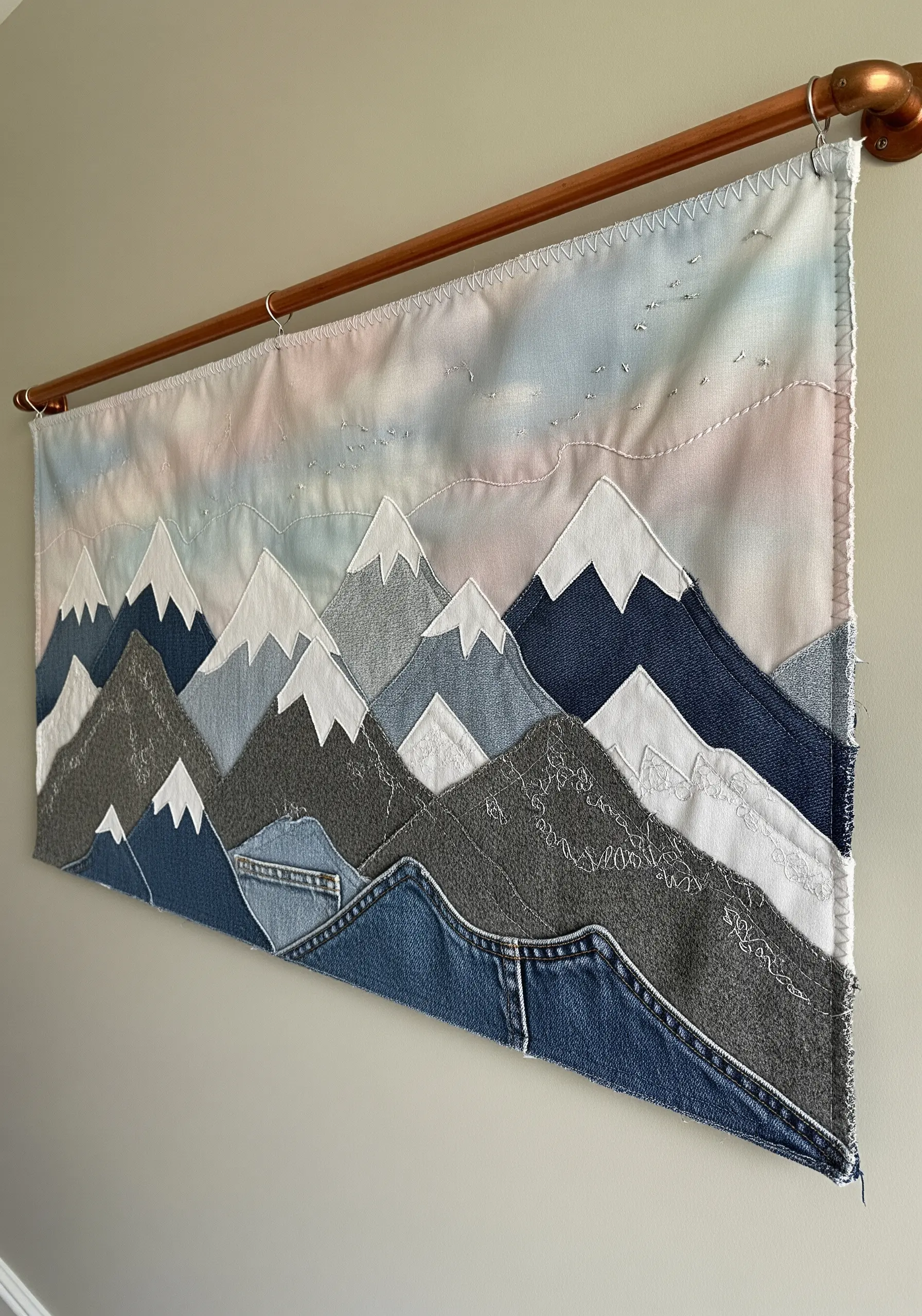 Mountain landscape wall hanging made from layered scraps of upcycled denim.