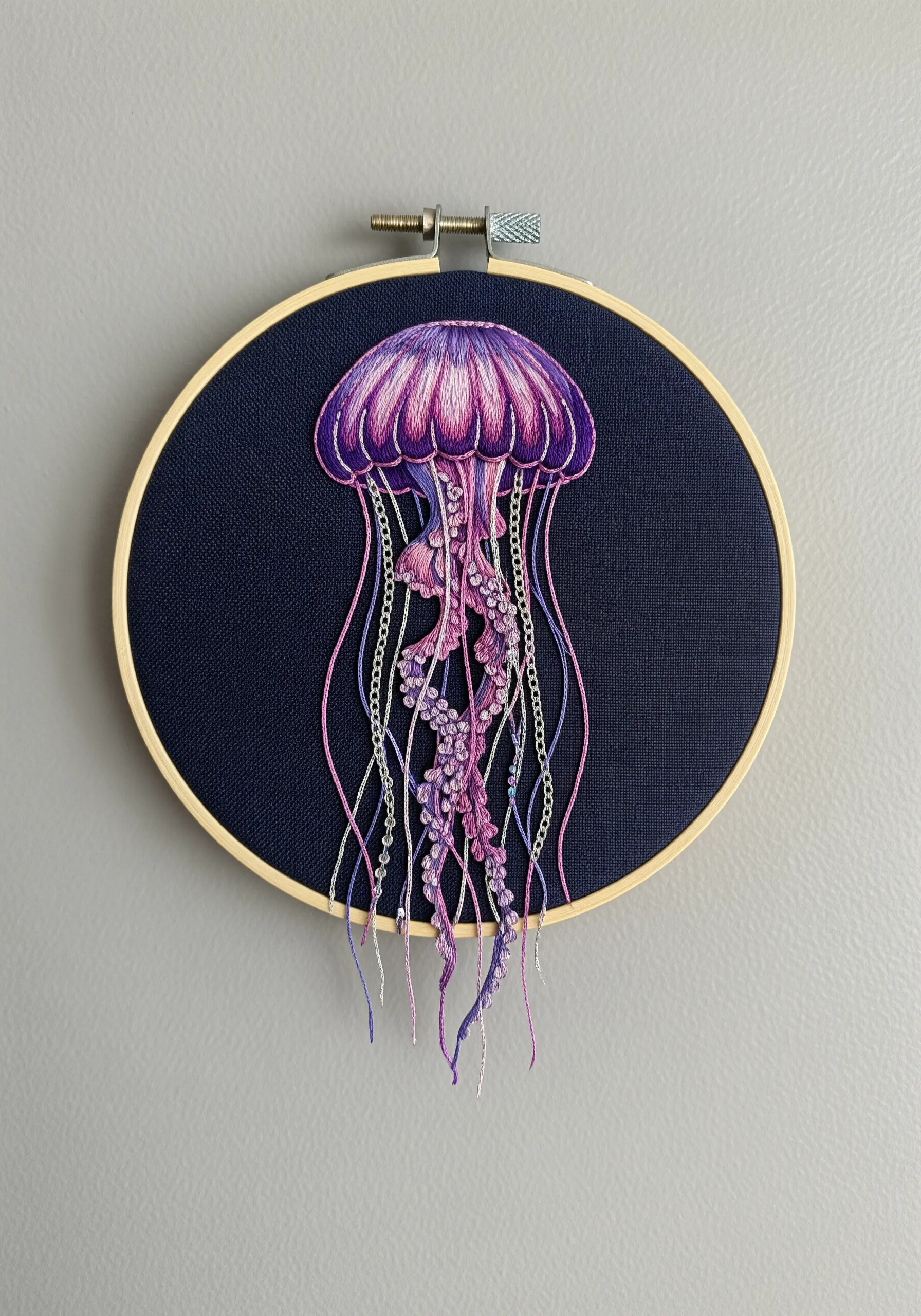 Detailed jellyfish embroidery with thread painting, French knots, and loose tentacles.