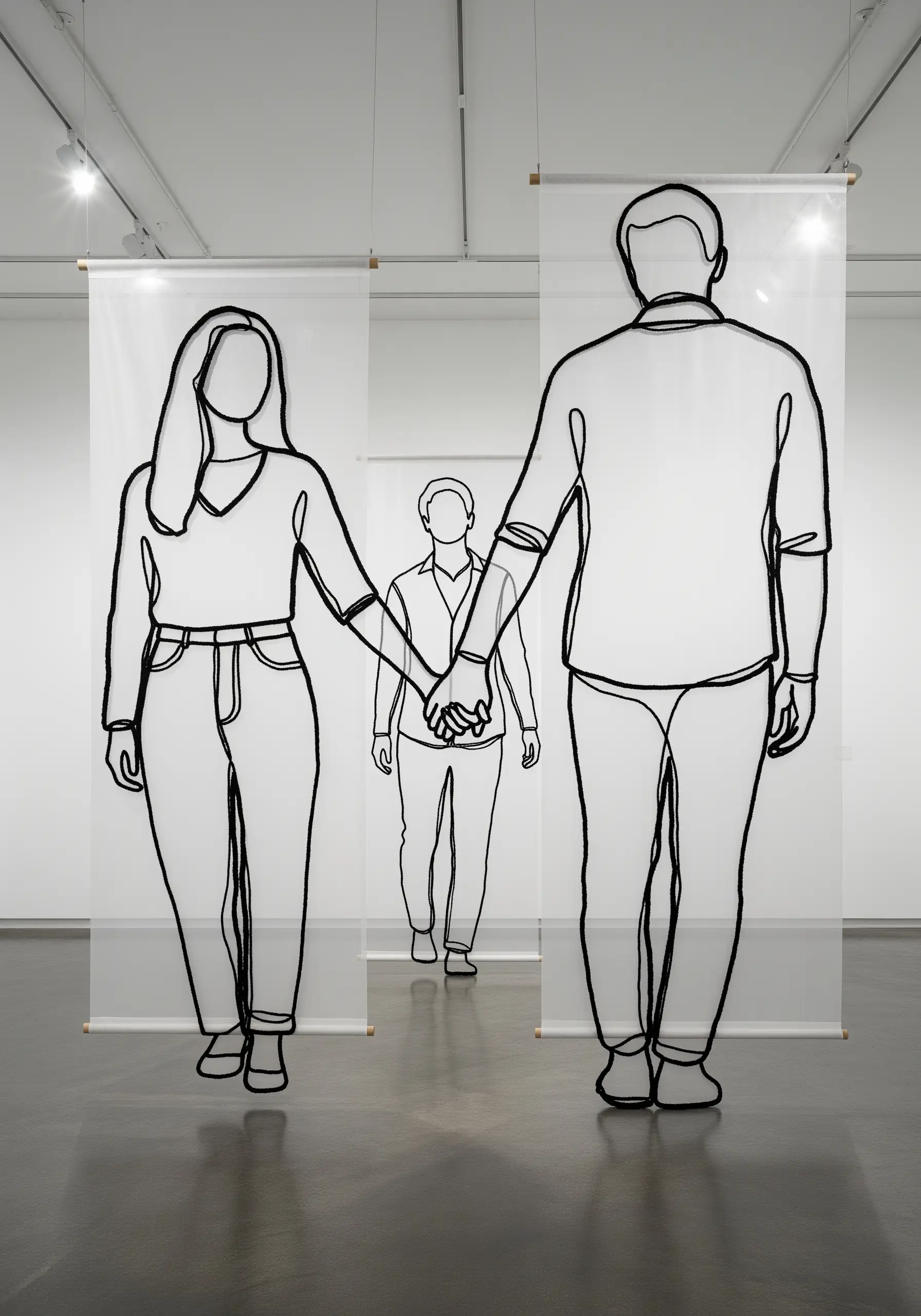 A large-scale installation of couple portraits embroidered on layered, transparent hanging banners.