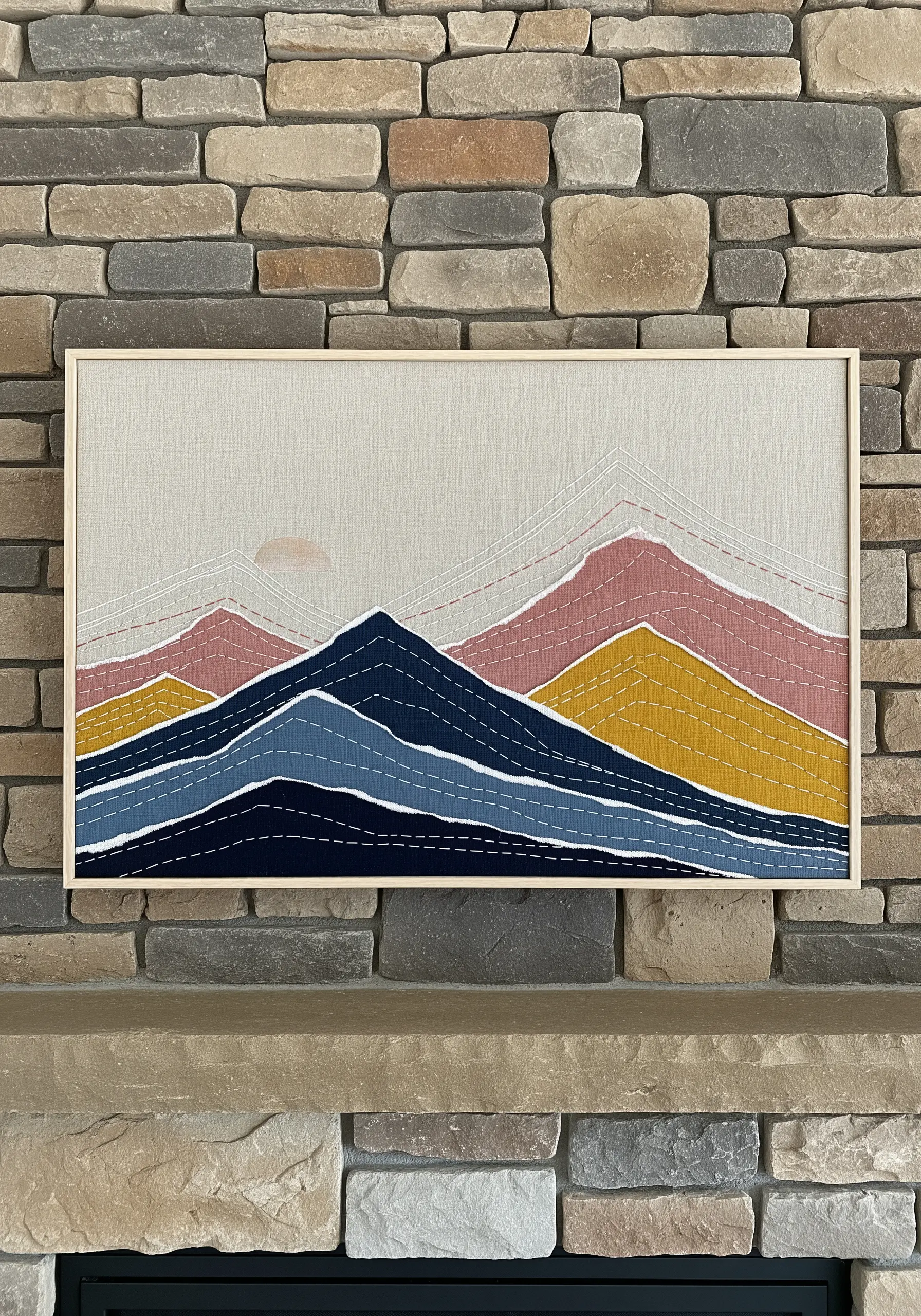 Framed fabric collage of mountains with hand-stitched line details.