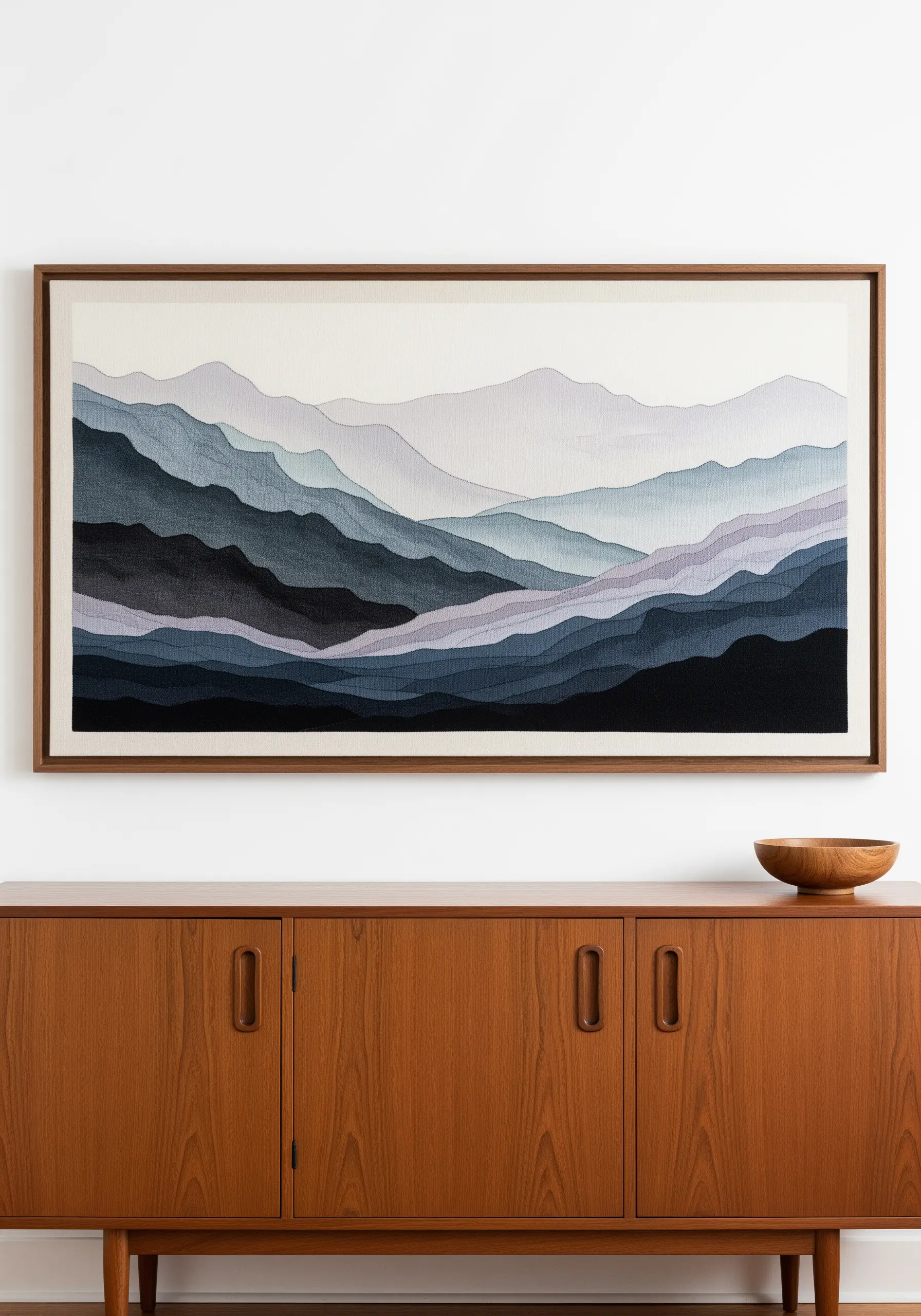 Embroidery of blue mountain ranges fading into the distance