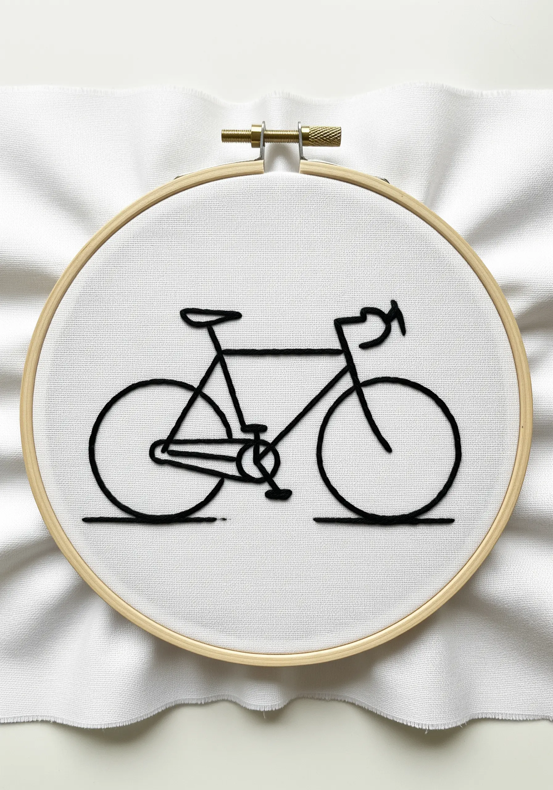 A minimalist line art bicycle stitched in black thread on a white background.