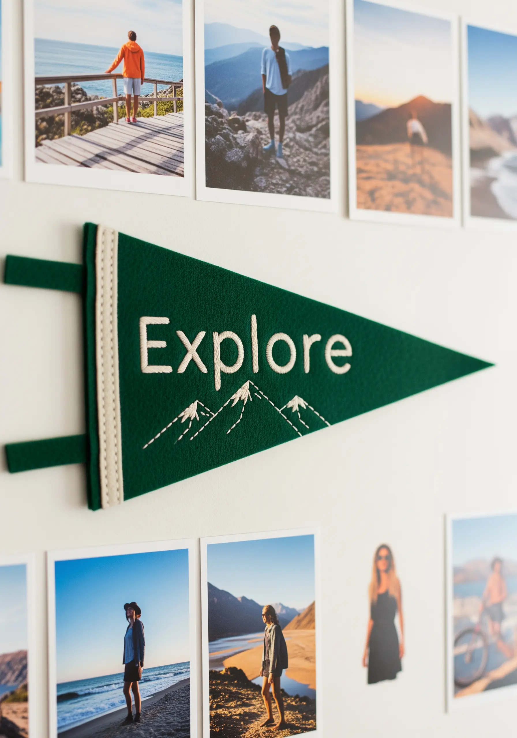 A green felt pennant with the word 'Explore' and mountain outlines embroidered in white.