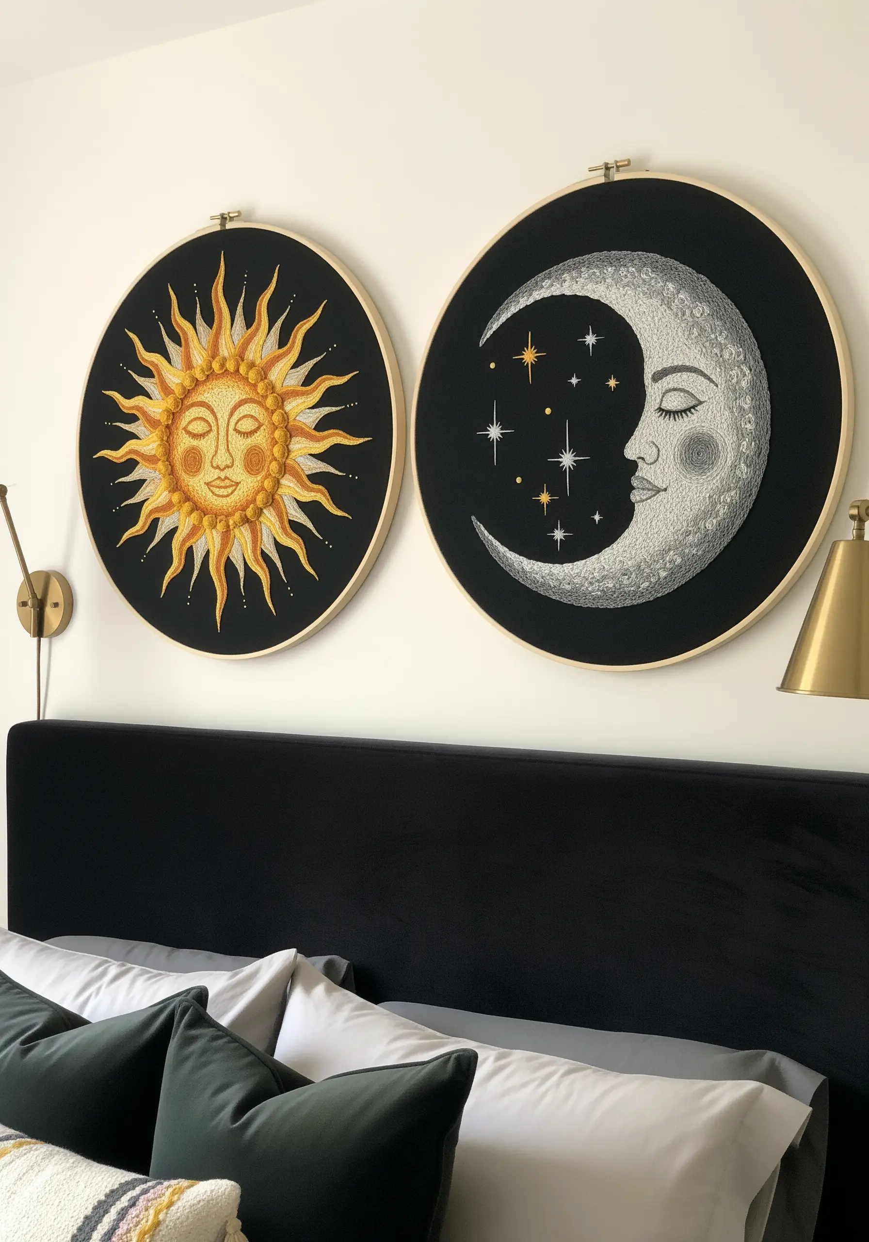 Two large embroidery hoops, one of a radiant sun and one of a serene moon, on black fabric.