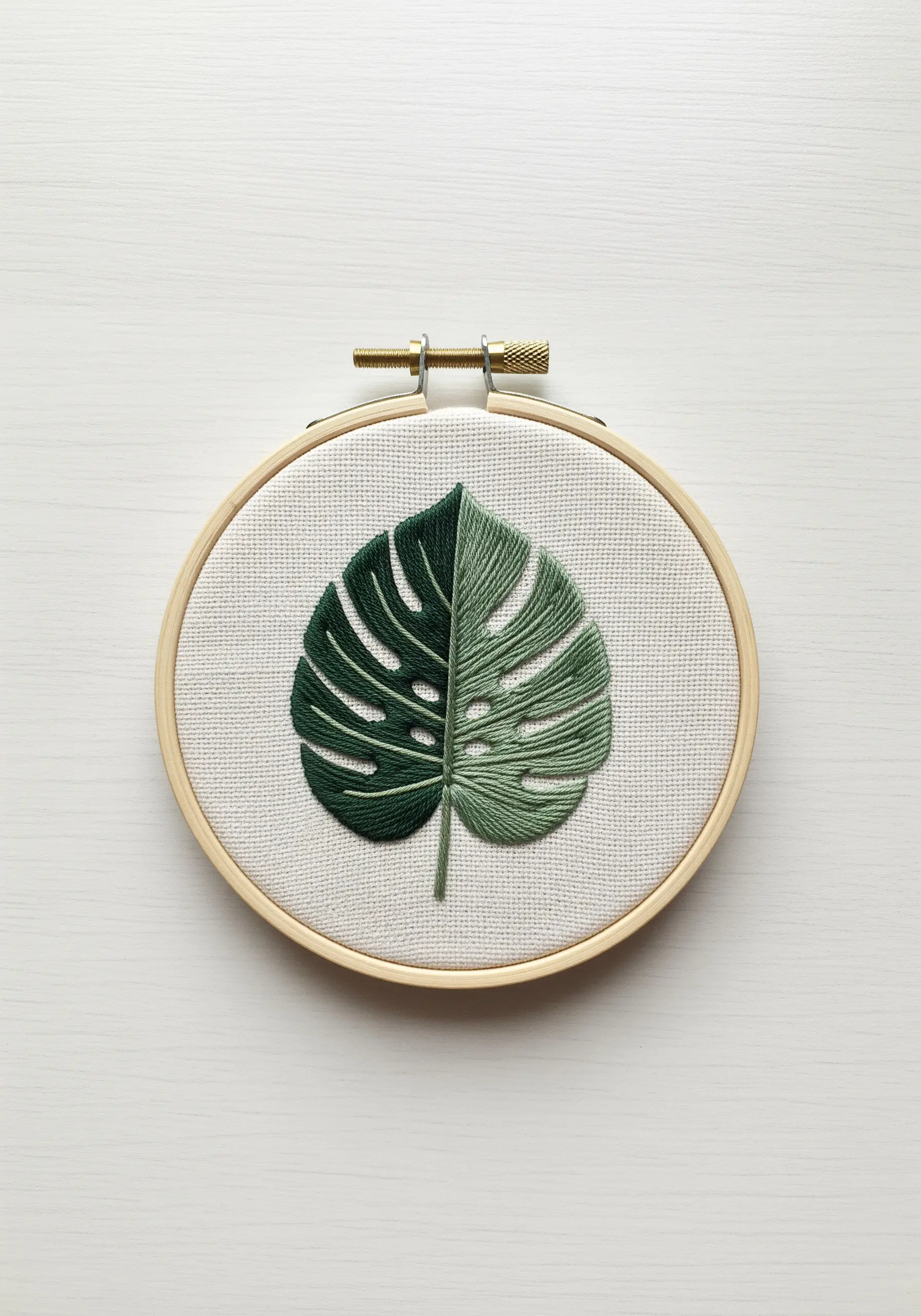 Split-color Monstera leaf embroidered with directional satin stitch.
