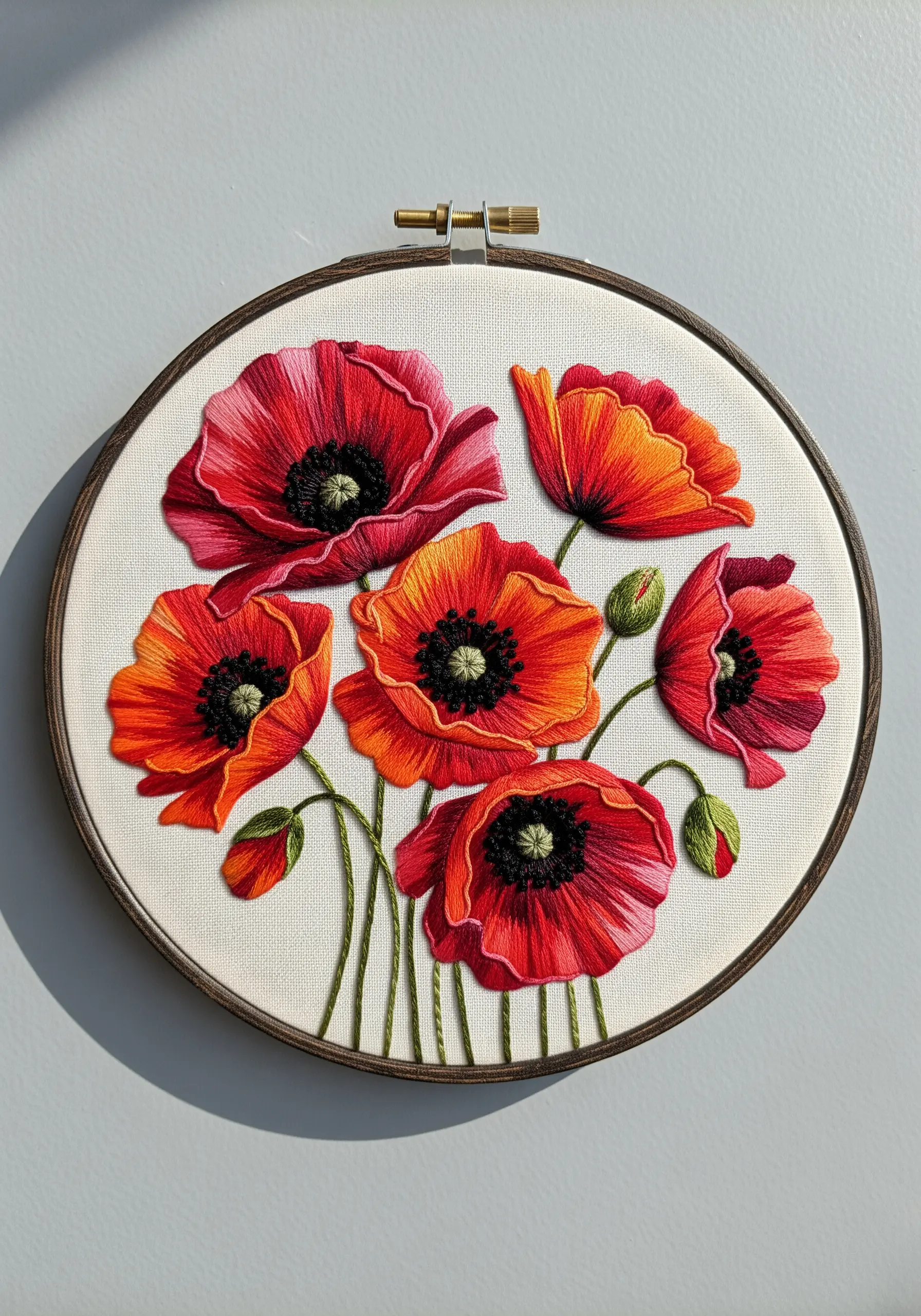 Realistic red and orange poppies created with long-and-short stitch blending.