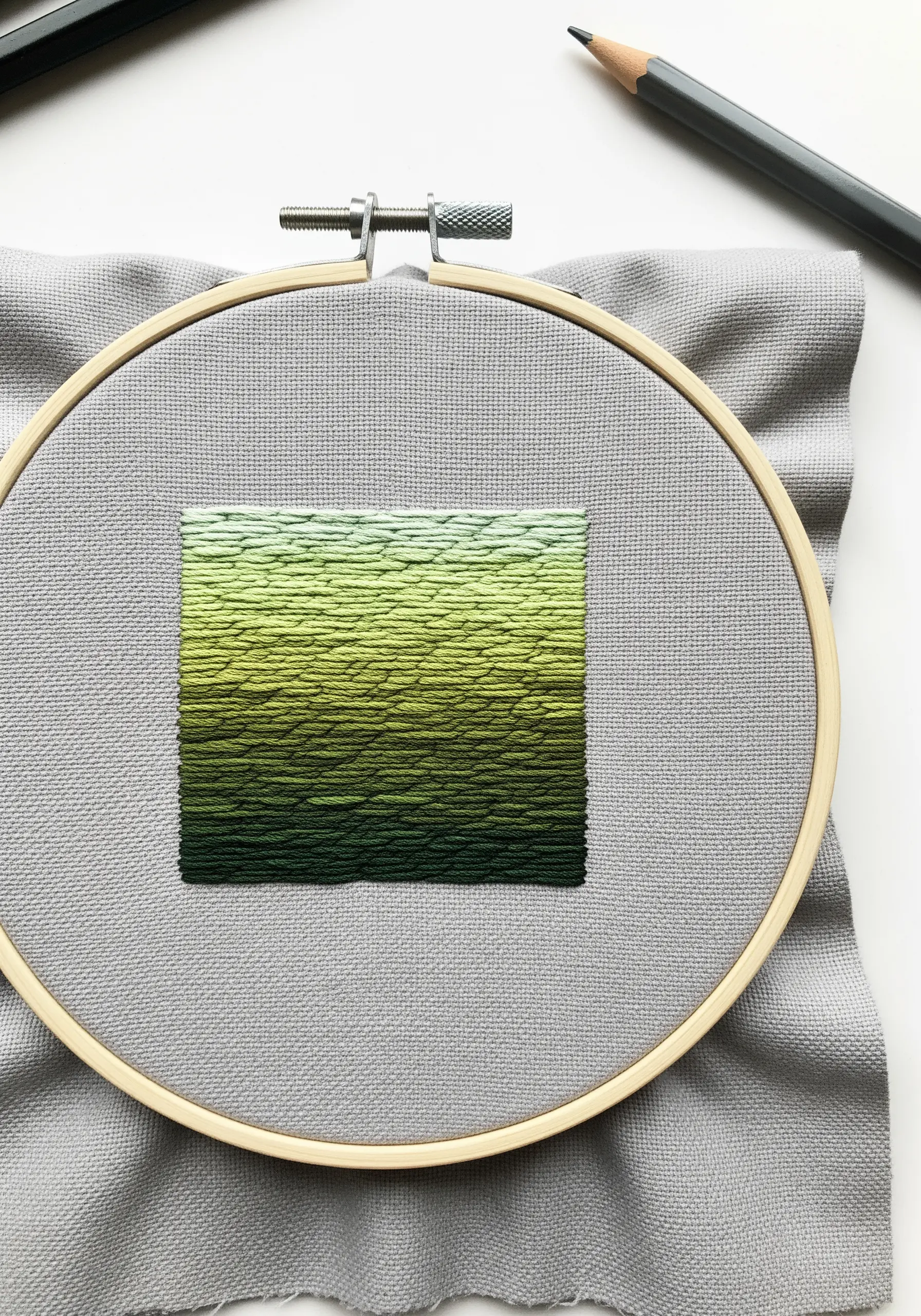 A square filled with a smooth green gradient using the long-and-short stitch.