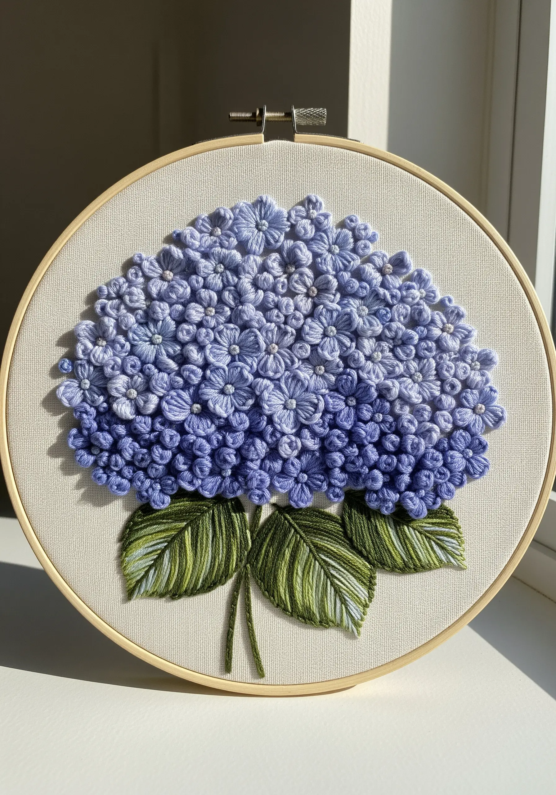 Dense blue hydrangea embroidered with layered lazy daisy stitches and French knots.