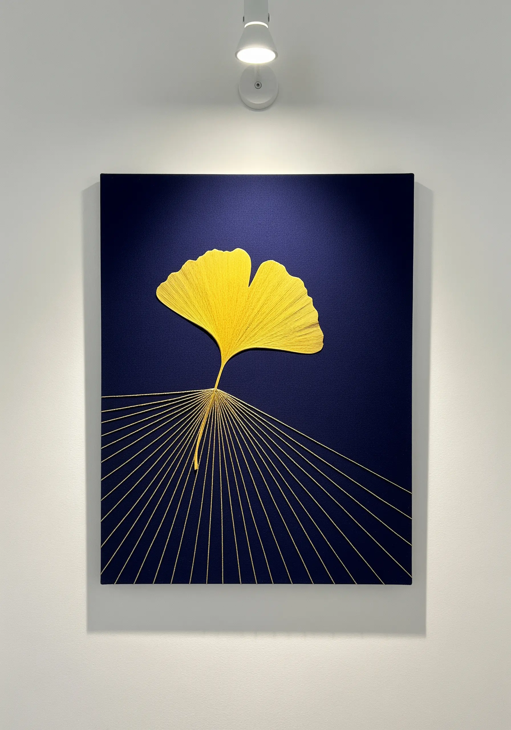 Thread-painted ginkgo leaf with radiating gold straight stitches on navy.