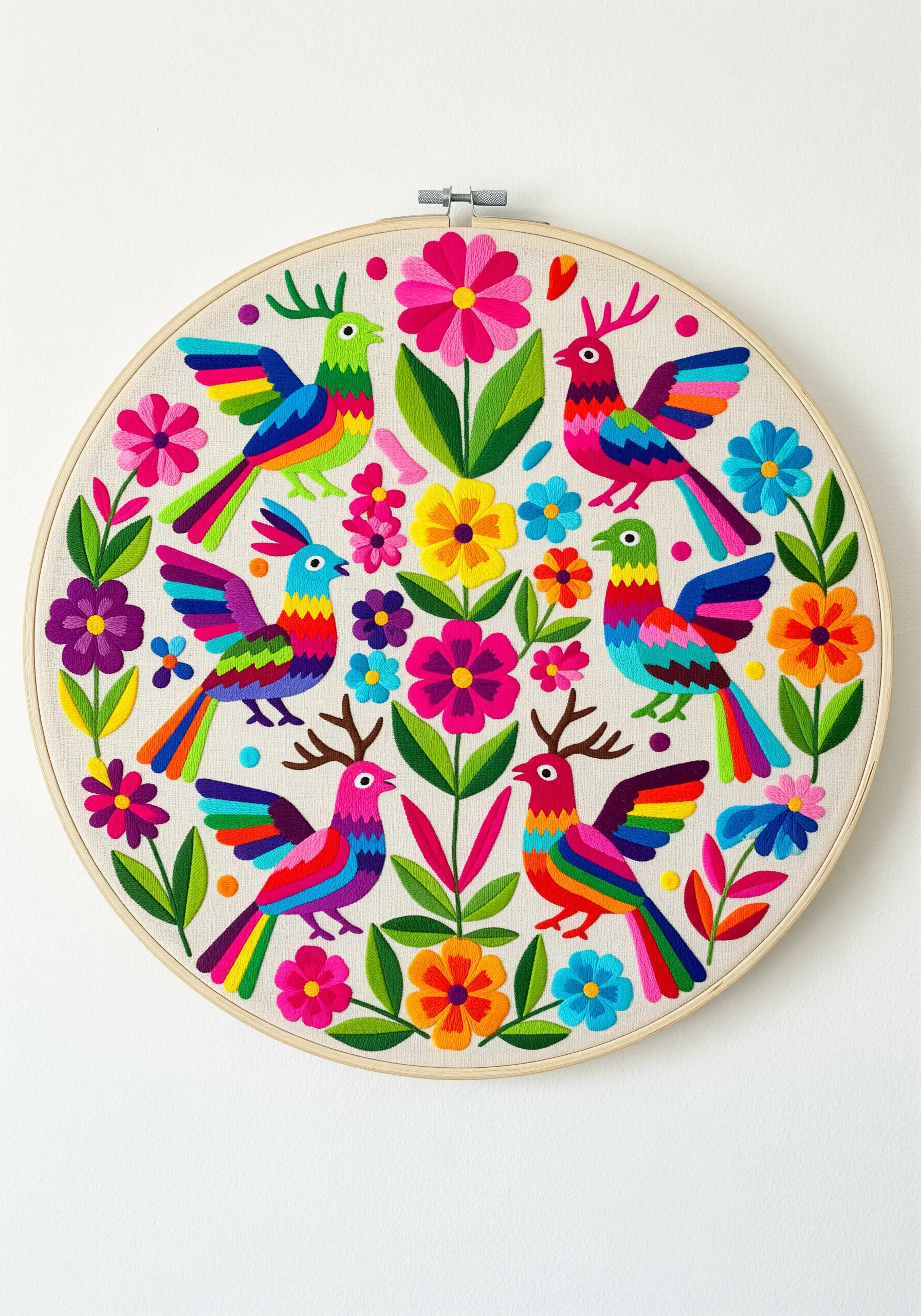Vibrant Mexican Otomi embroidery with colorful birds and flowers in a hoop.