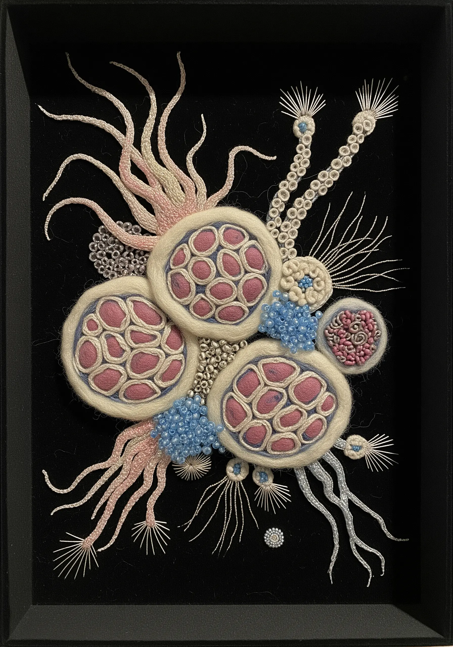 Abstract 3D fiber art inspired by cells, using felt, beads, and dimensional embroidery.