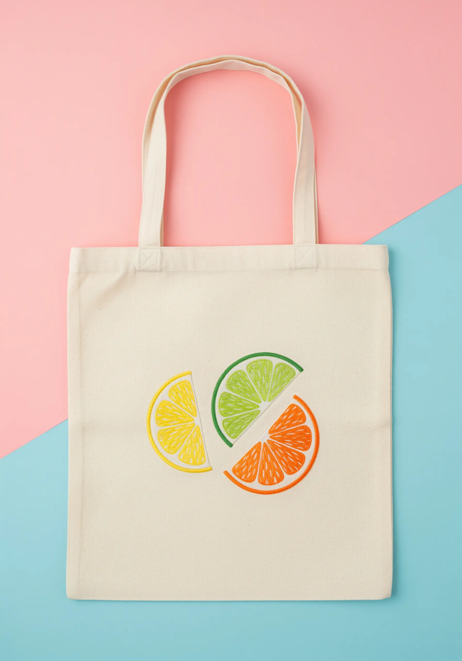 Stylized slices of lemon, lime, and orange on a natural canvas tote bag.