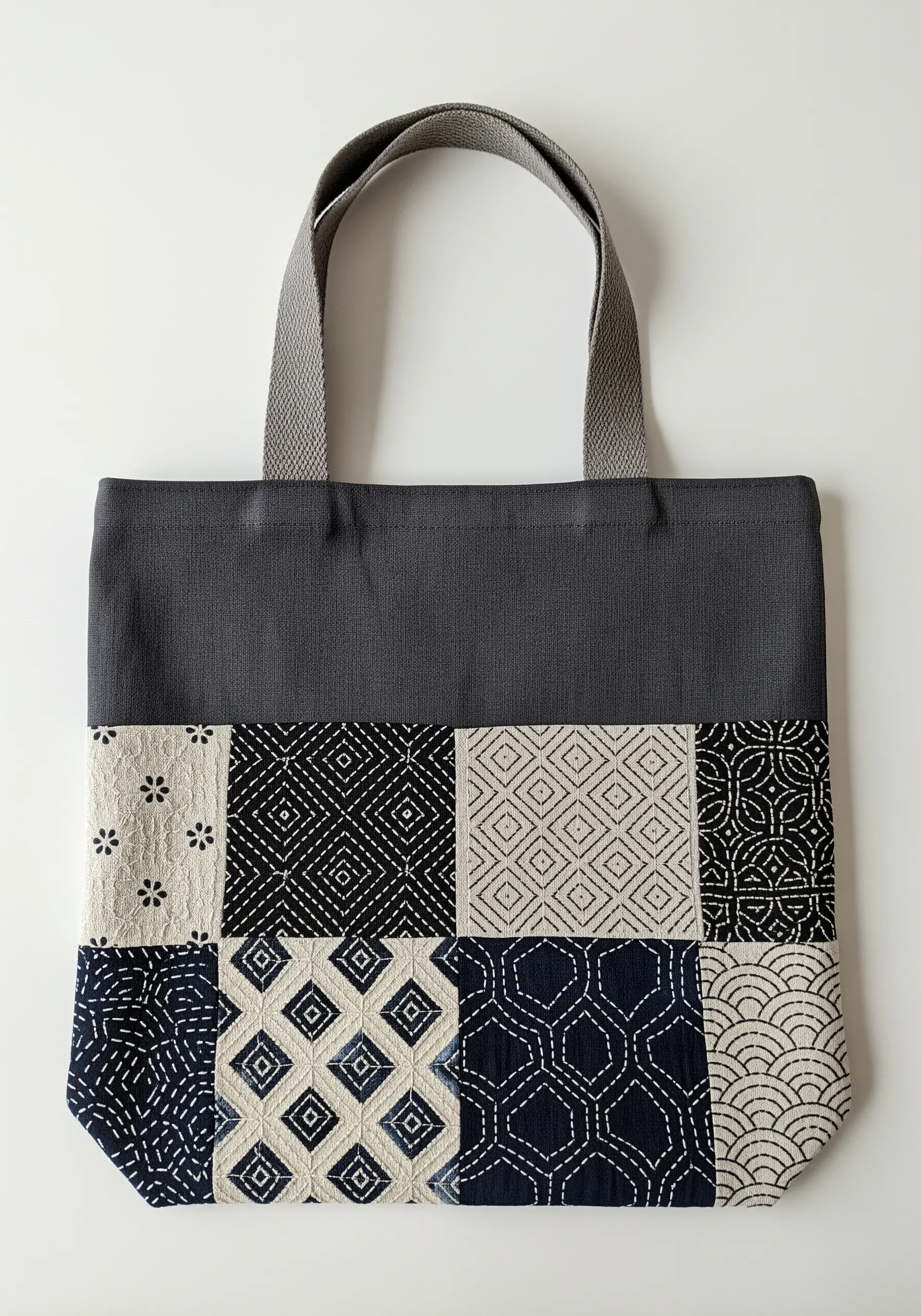 Japanese sashiko embroidery on a patchwork tote bag with geometric patterns.