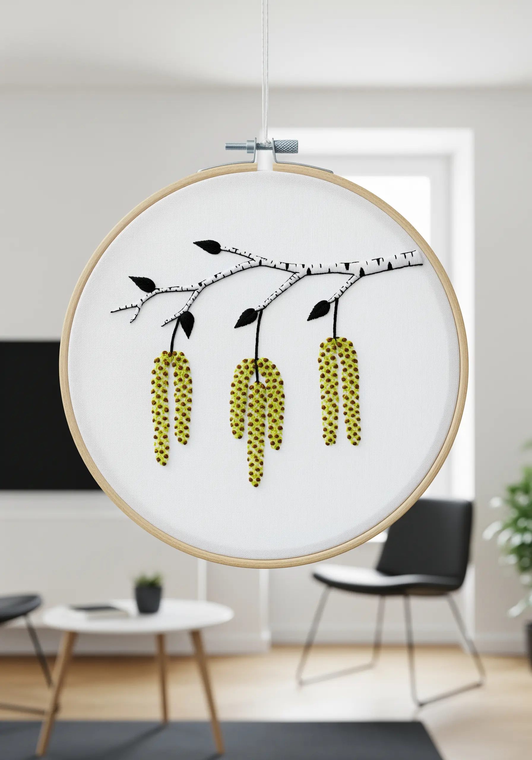 A minimalist embroidery of a birch branch with three hanging catkins made of French knots.