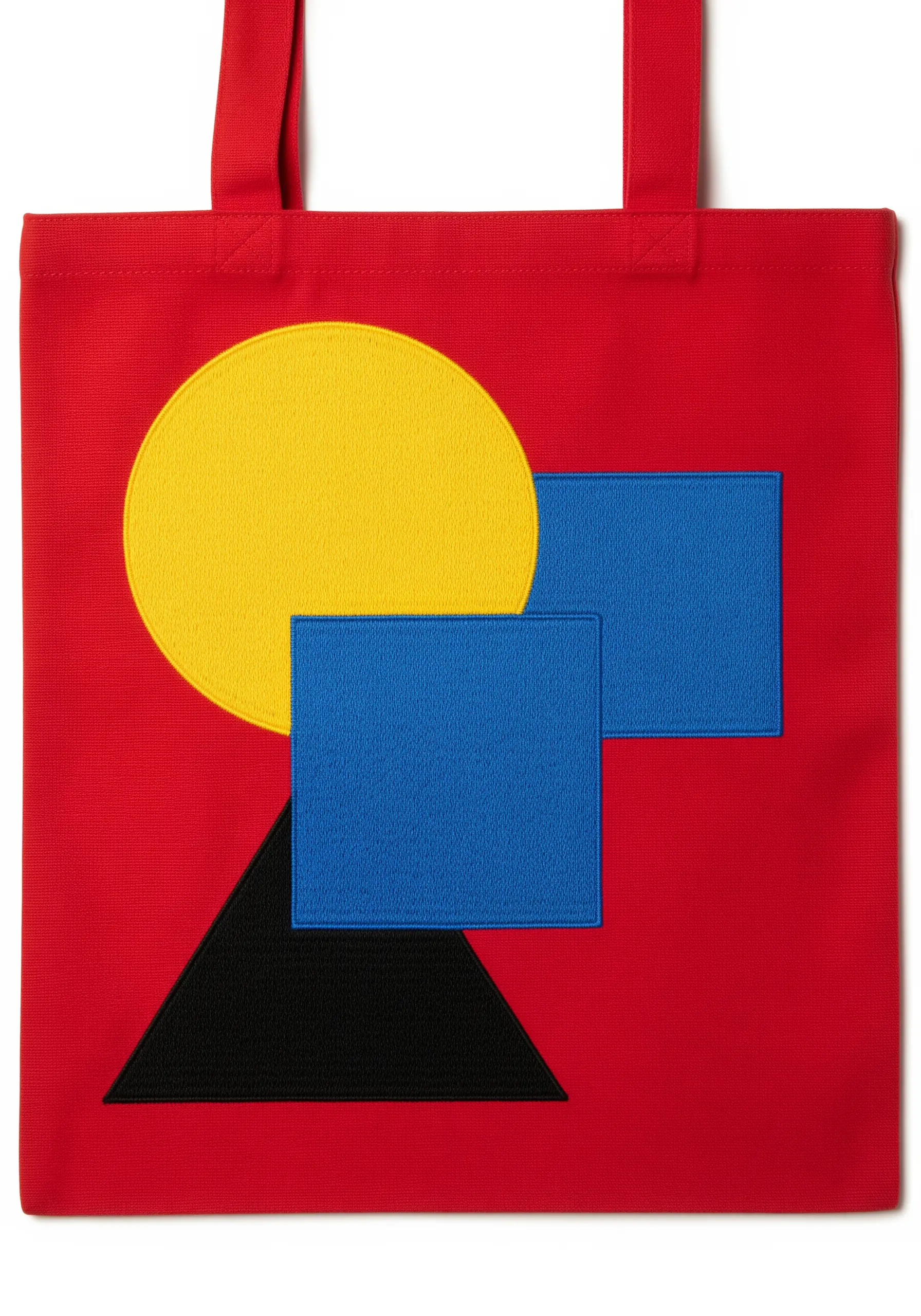 Geometric shapes—a yellow circle, blue rectangles, and a black triangle—on a bright red tote.