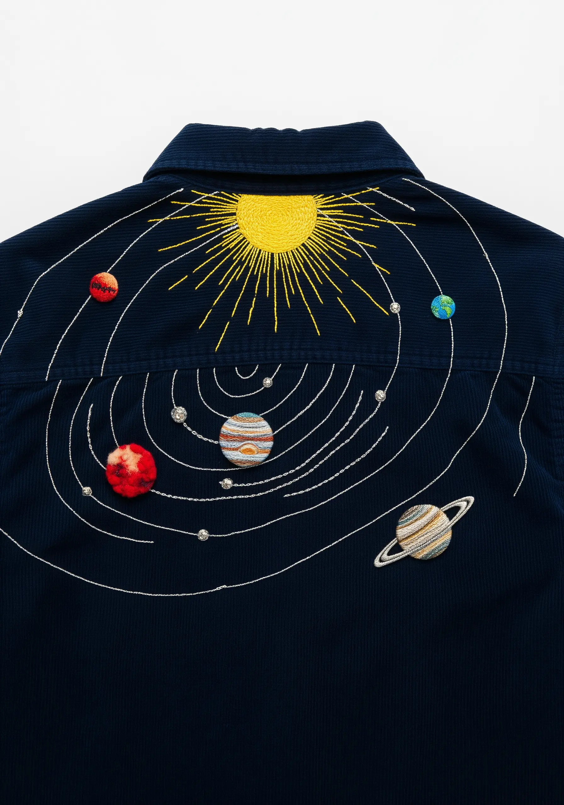 Embroidered solar system with textural planets and a bright yellow sun on a navy corduroy shirt.